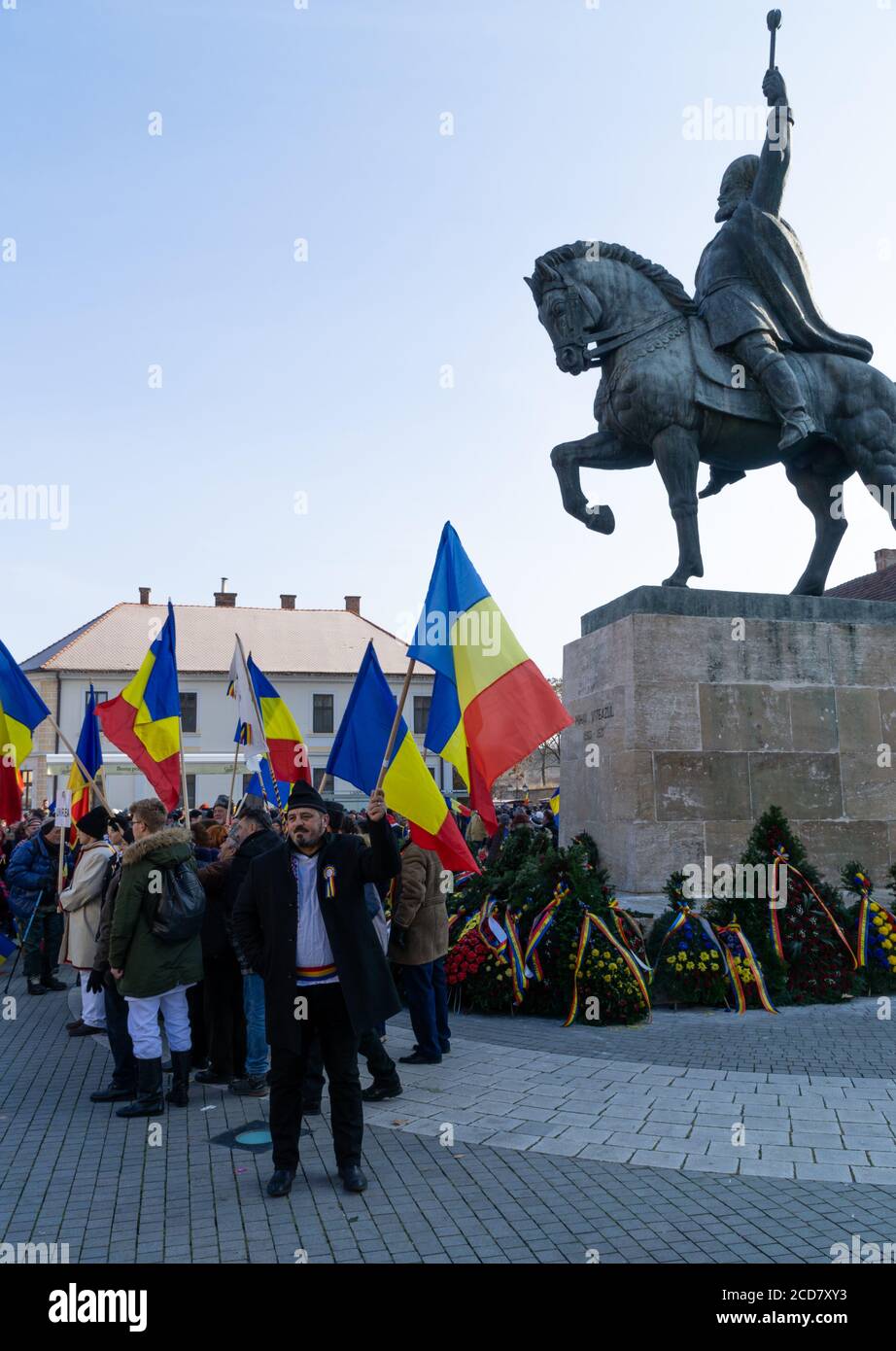 Alba Iulia, Romania - 01.12.2018: Persone che sventolano bandiere rumene di fronte alla statua di Michele il Brave Foto Stock