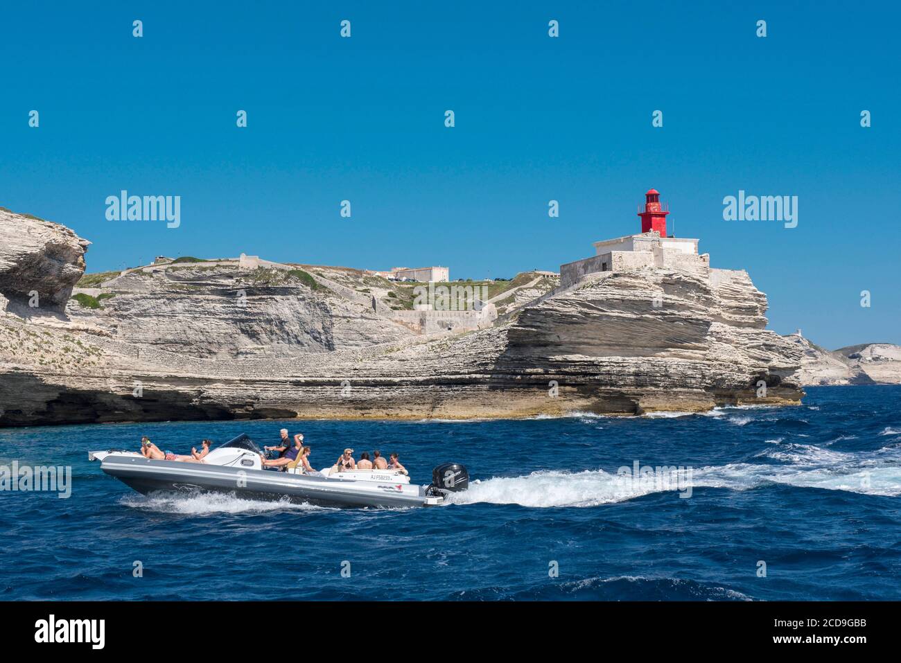 Francia, Corse du Sud, Bonifacio, le barche di camminare passano vicino al faro di Madonetta per visitare la grotta di Sdragonato la cui apertura sul cielo rappresenta l'isola di Corsica Foto Stock