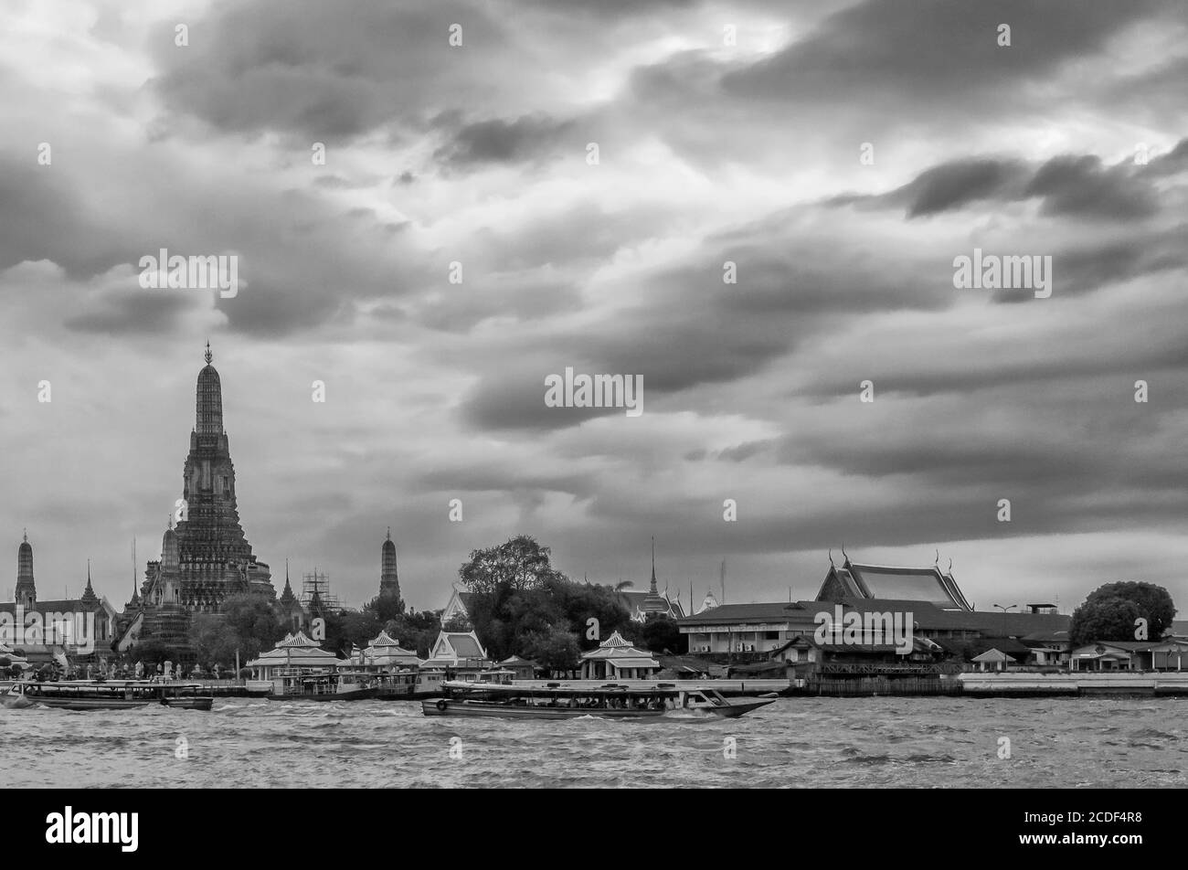 Bella vista del famoso tempio buddista di Dawn, Wat Arun, sul fiume Chao Phraya, contro un cielo drammatico, Bangkok, Thailandia Foto Stock