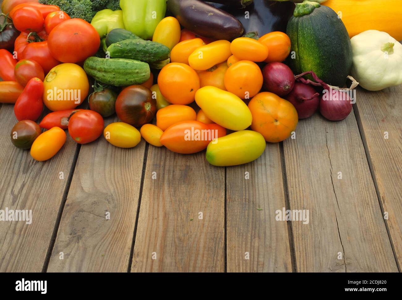 Molte verdure diverse non amidacee su sfondo di legno. Concetto di raccolto e stagione estiva. Foto Stock