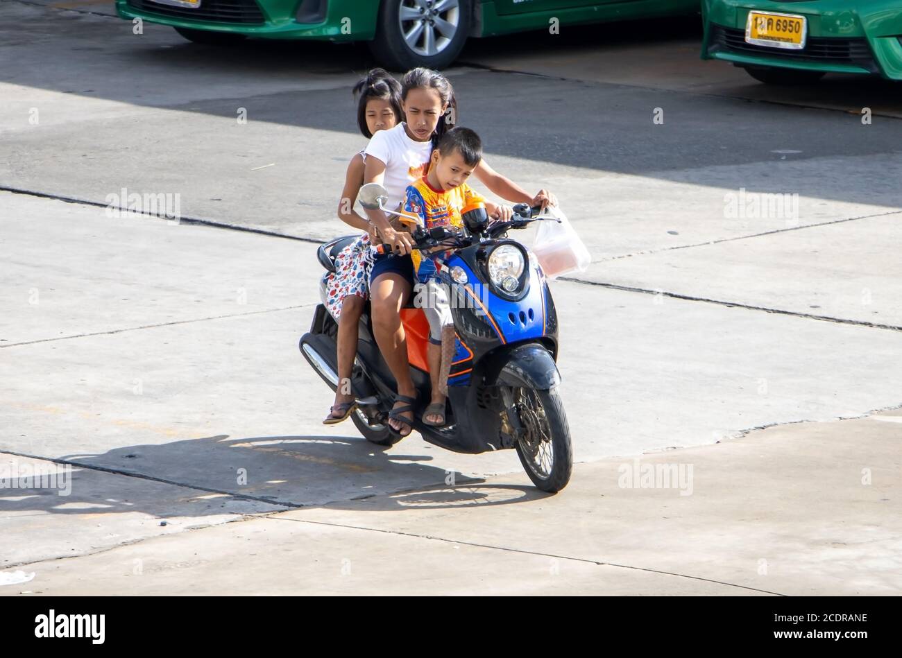 SAMUT PRAKAN, THAILANDIA, 26 2020 GIUGNO, UNA donna guida due bambini su  una moto. Una madre guida uno scooter con sua figlia e suo figlio Foto  stock - Alamy