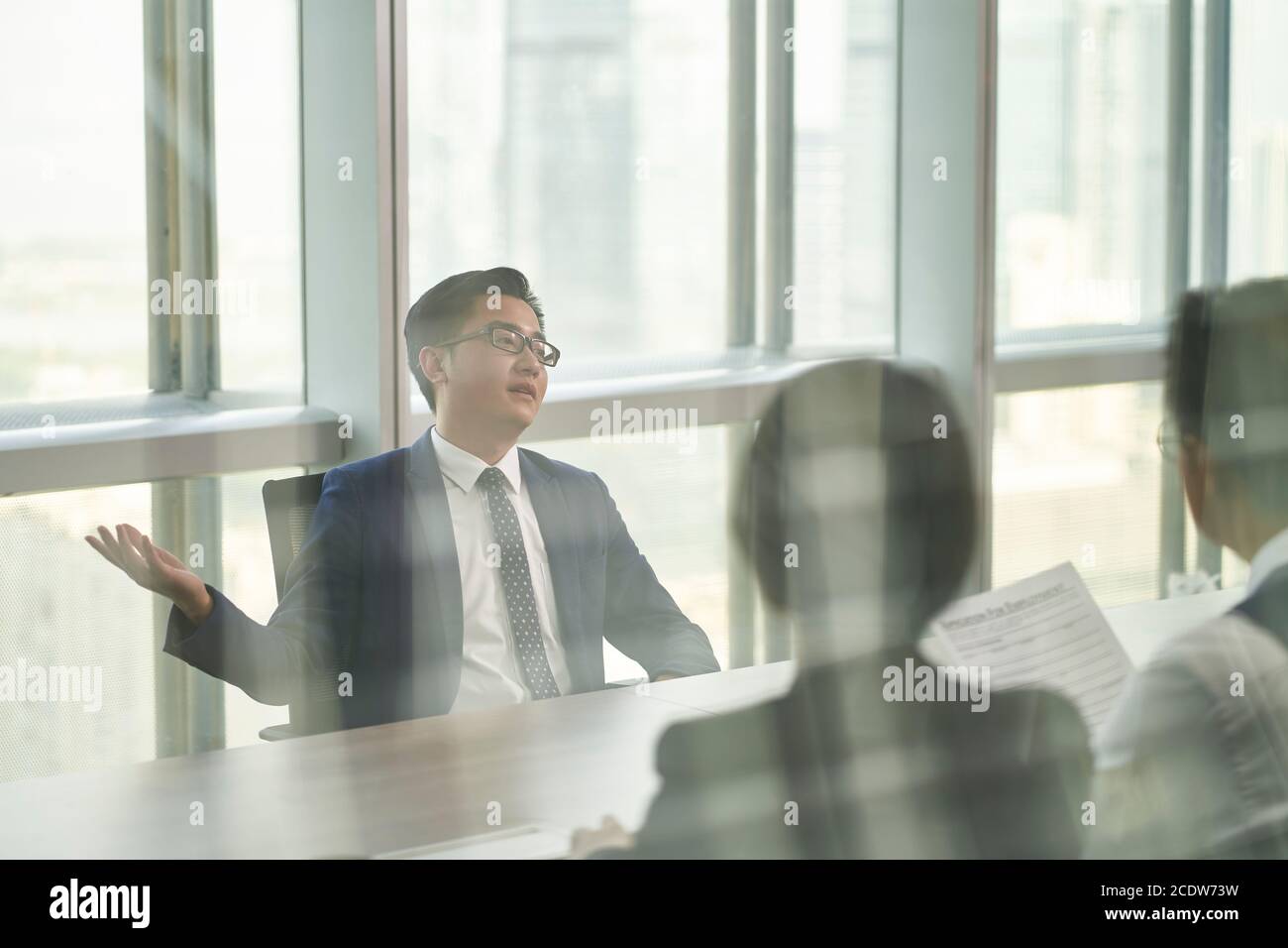 uomo d'affari asiatico intervistato da un team di hr dirigenti in un ufficio moderno Foto Stock