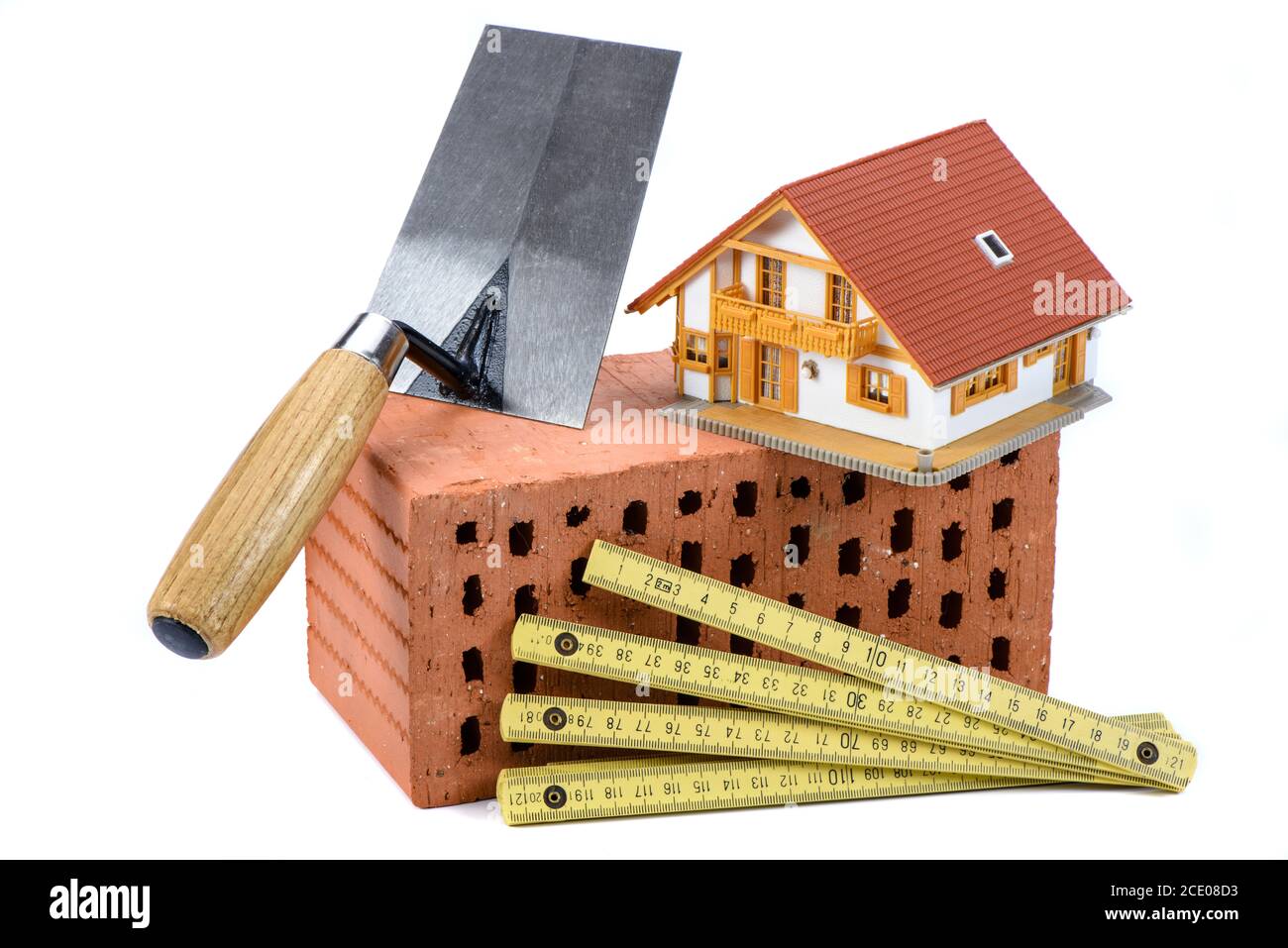 Strumenti e mattone come simbolo per la costruzione della casa Foto Stock