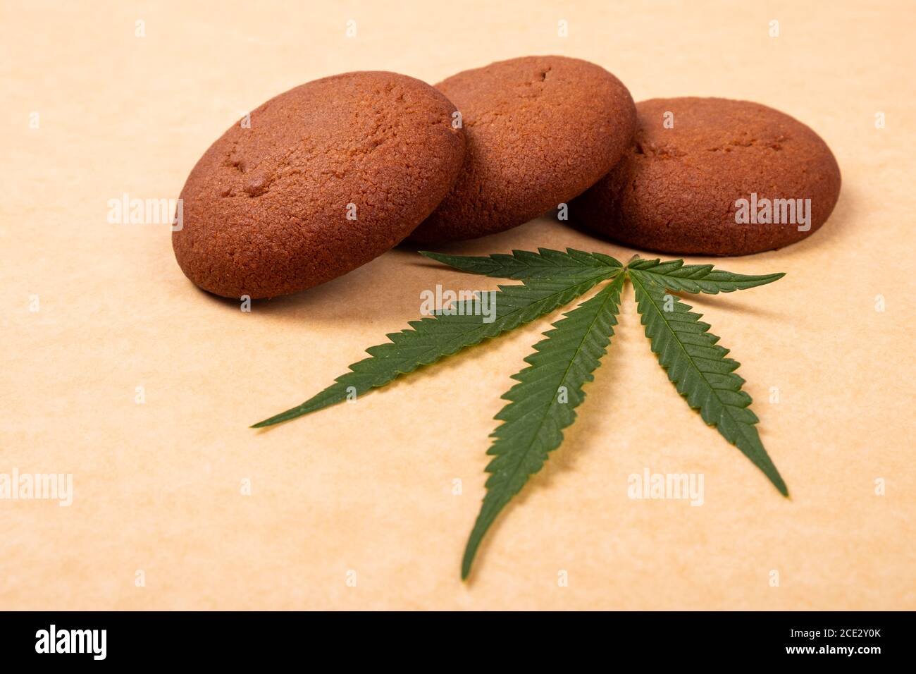 dolci di cannabis, biscotti di marijuana e foglie verdi da vicino. Foto Stock