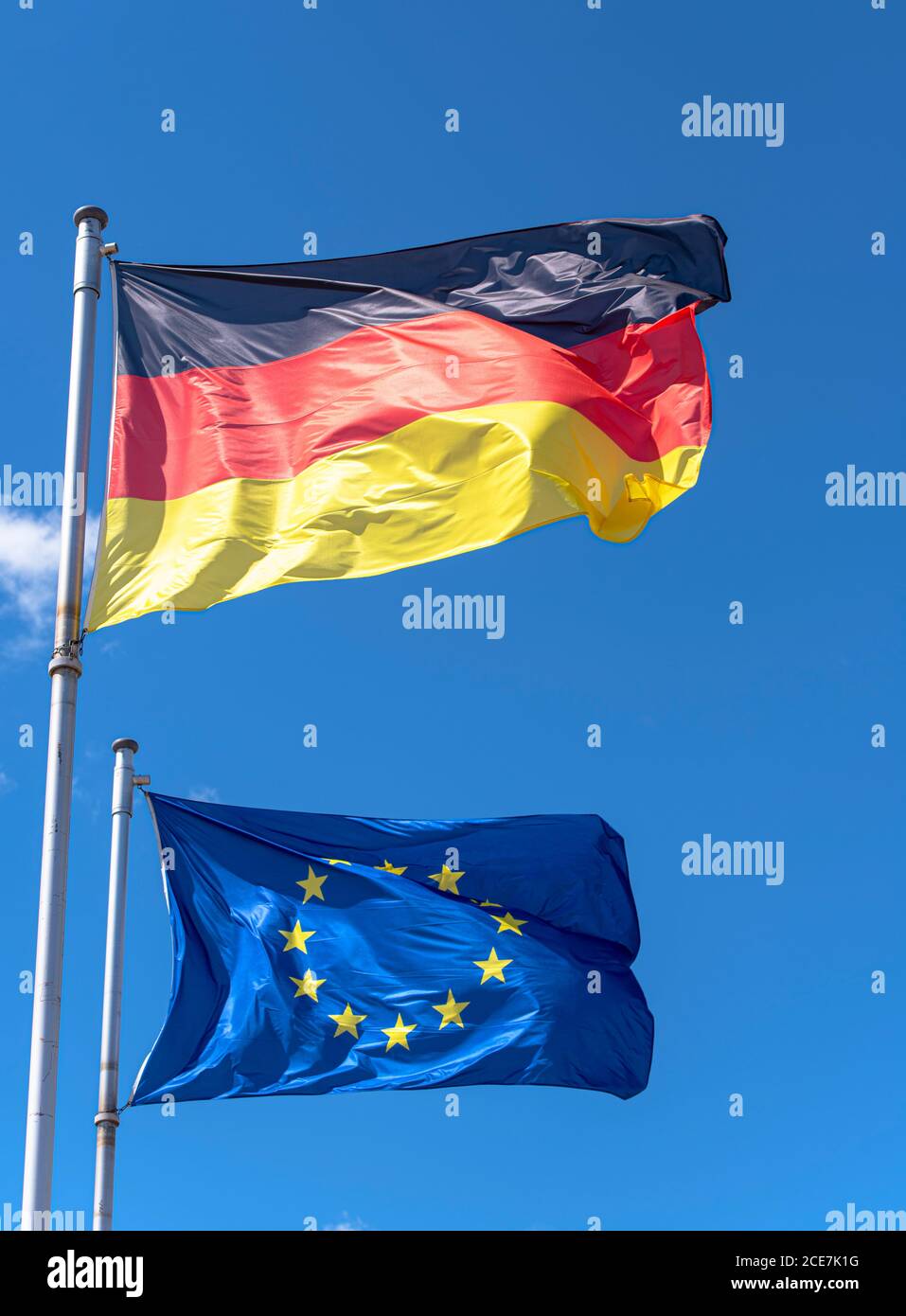 La Germania e l'Unione europea bandiere contro il cielo blu a Berlino Foto Stock