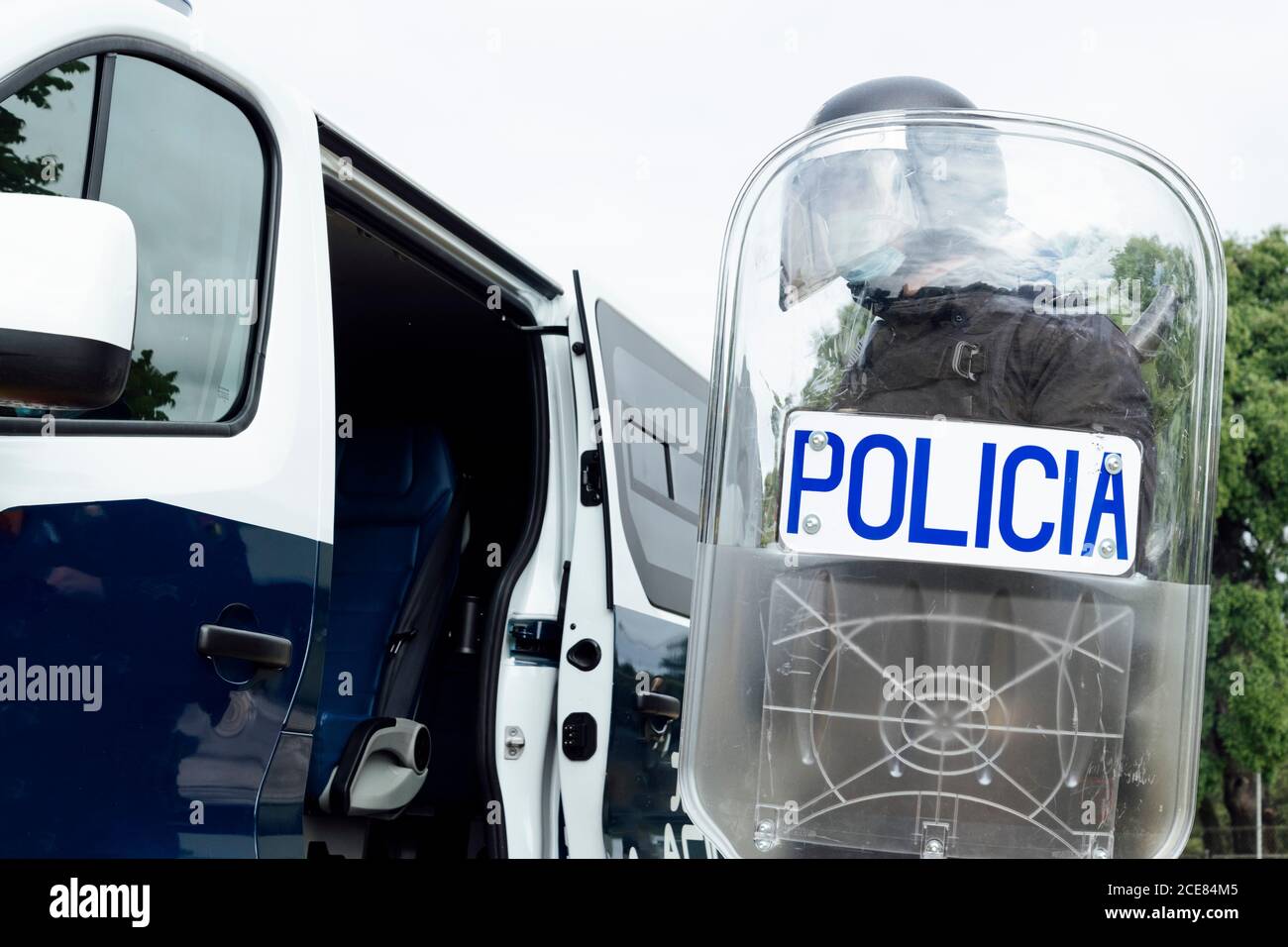 Crop inriconoscibile poliziotto swat in casco corazza e medico maschera che va al funzionamento con fucile d'assalto Foto Stock