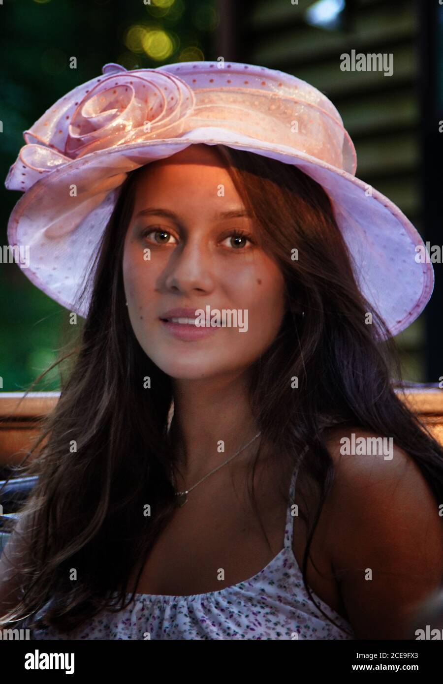 La giovane donna indossa un cappello vintage al sole della sera. Foto Stock