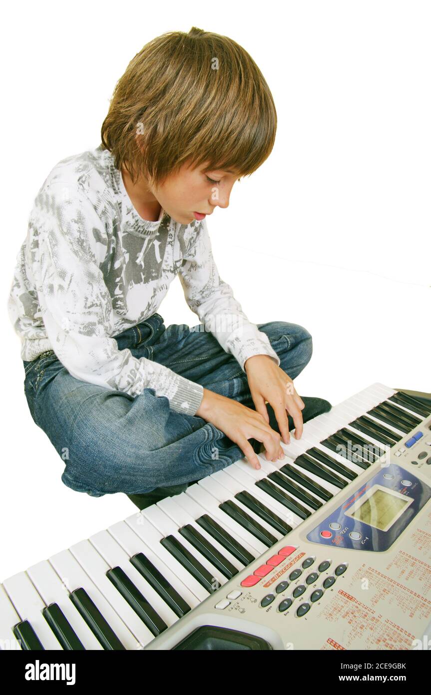 Simpatico ragazzo che suona piano, isolato Foto Stock