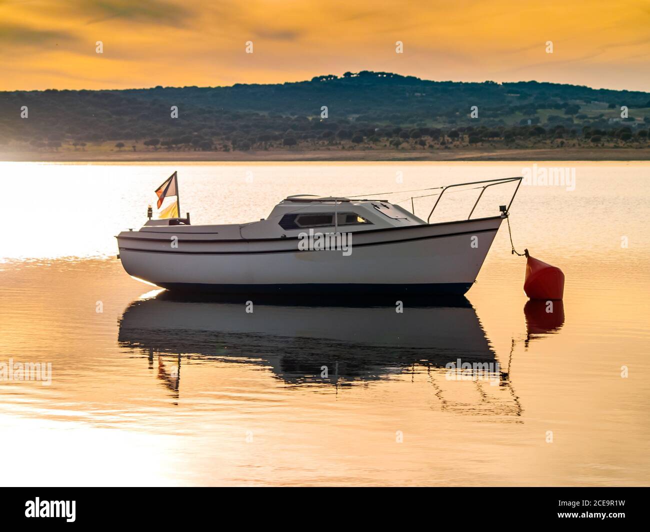Barche sul lago al tramonto, ormeggiato con una boa e calma acqua nel serbatoio di La Maya (Salamanca) Foto Stock