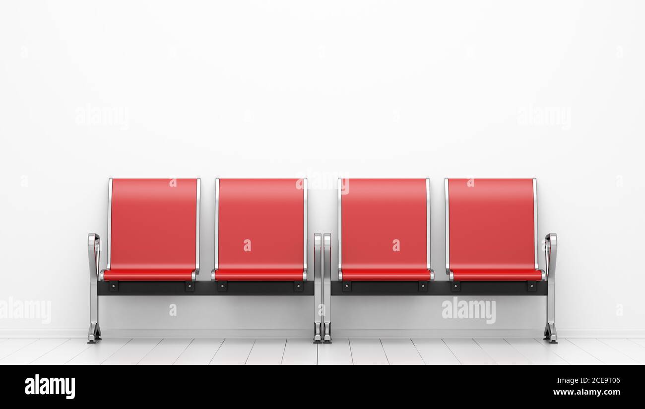 sedie rosse di attesa di fronte al muro bianco Foto Stock