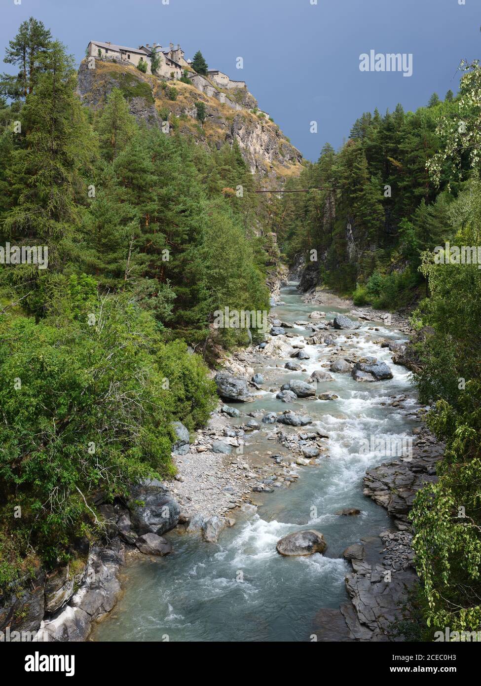 DOPO LA TEMPESTA, FORT QUEYRAS SULLO SFONDO DI NUVOLE SCURE, E IL FIUME GUIL. Château-Ville-Vieille, Hautes-Alpes, Francia. Foto Stock