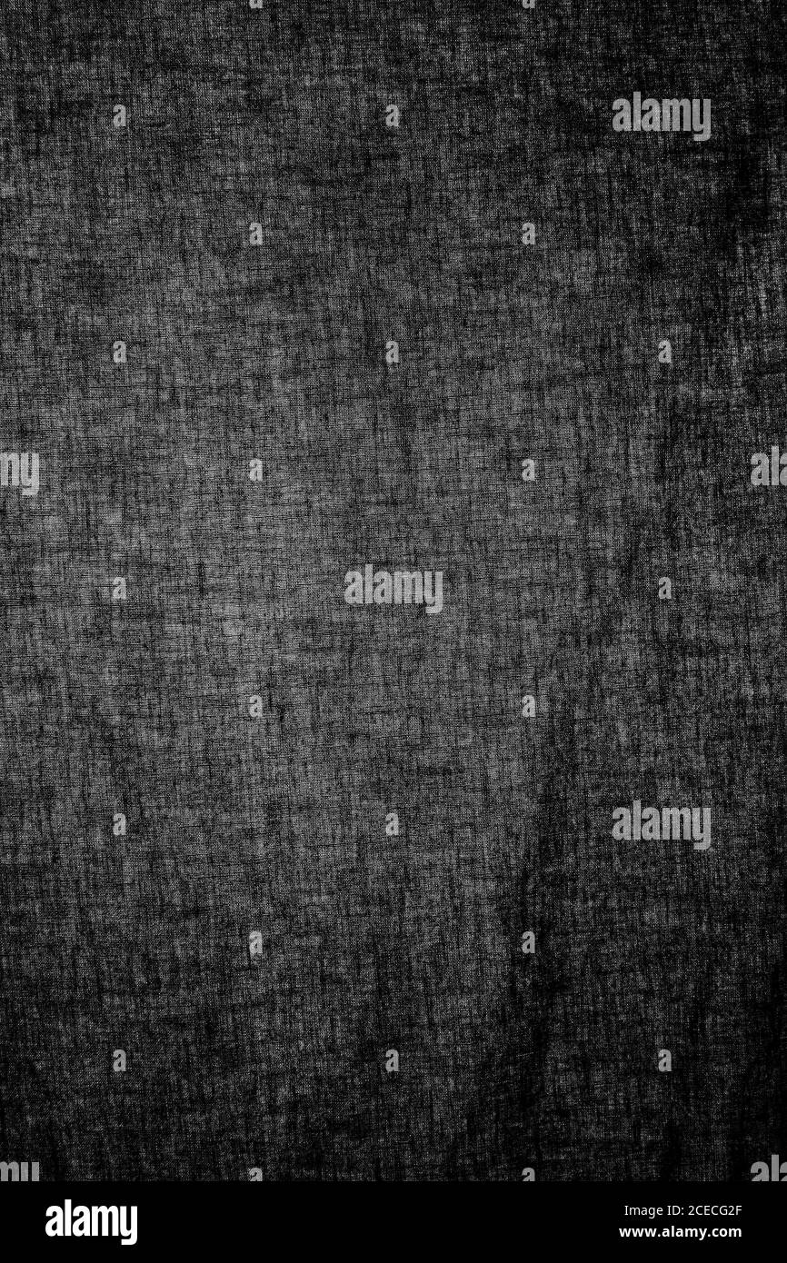 Pezzo di stoffa nera in primo piano con luce che brilla attraverso Foto  stock - Alamy