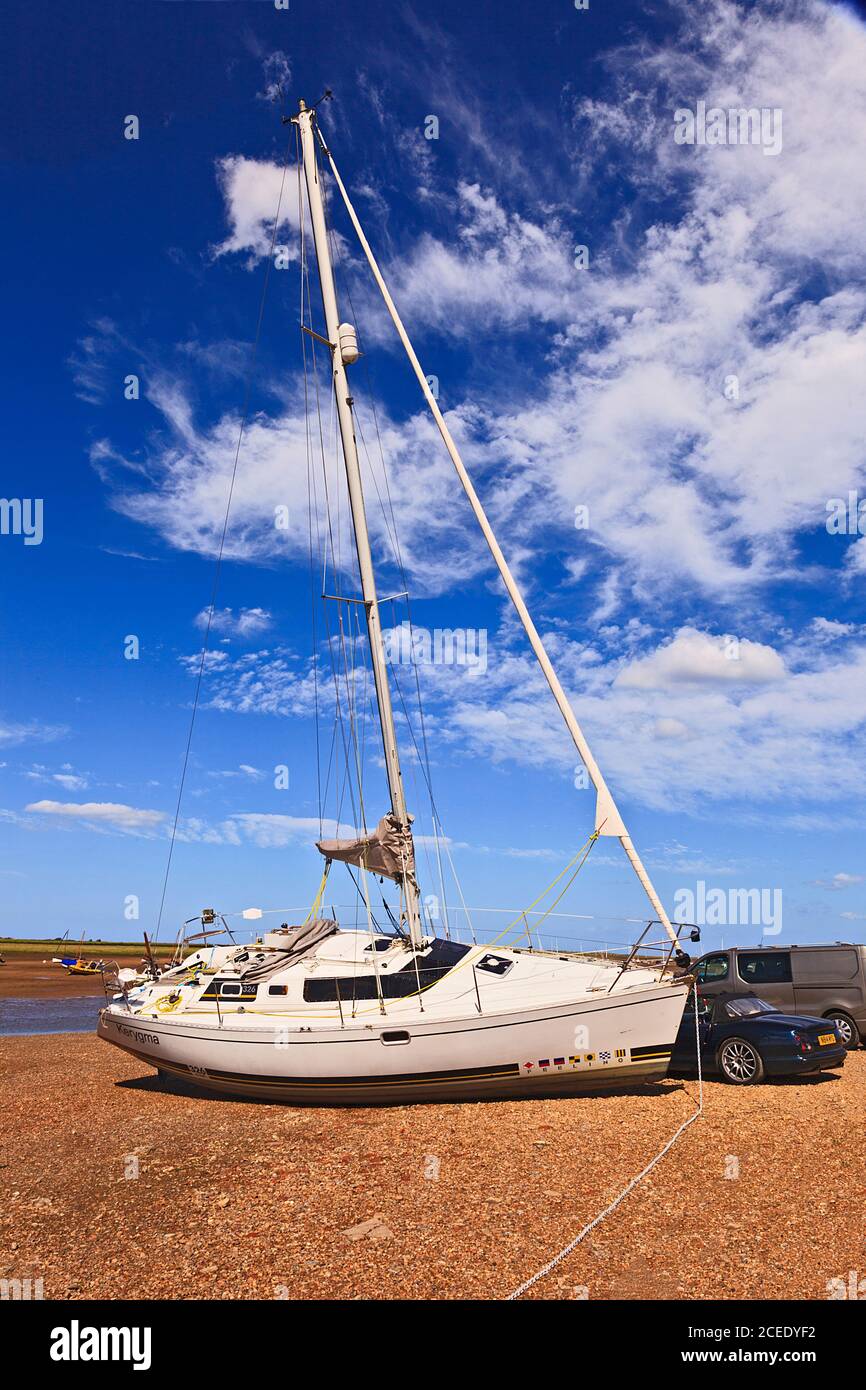 Yacht in barca a bassa marea a Brancaster Staith, Norfolk, Regno Unito Foto Stock