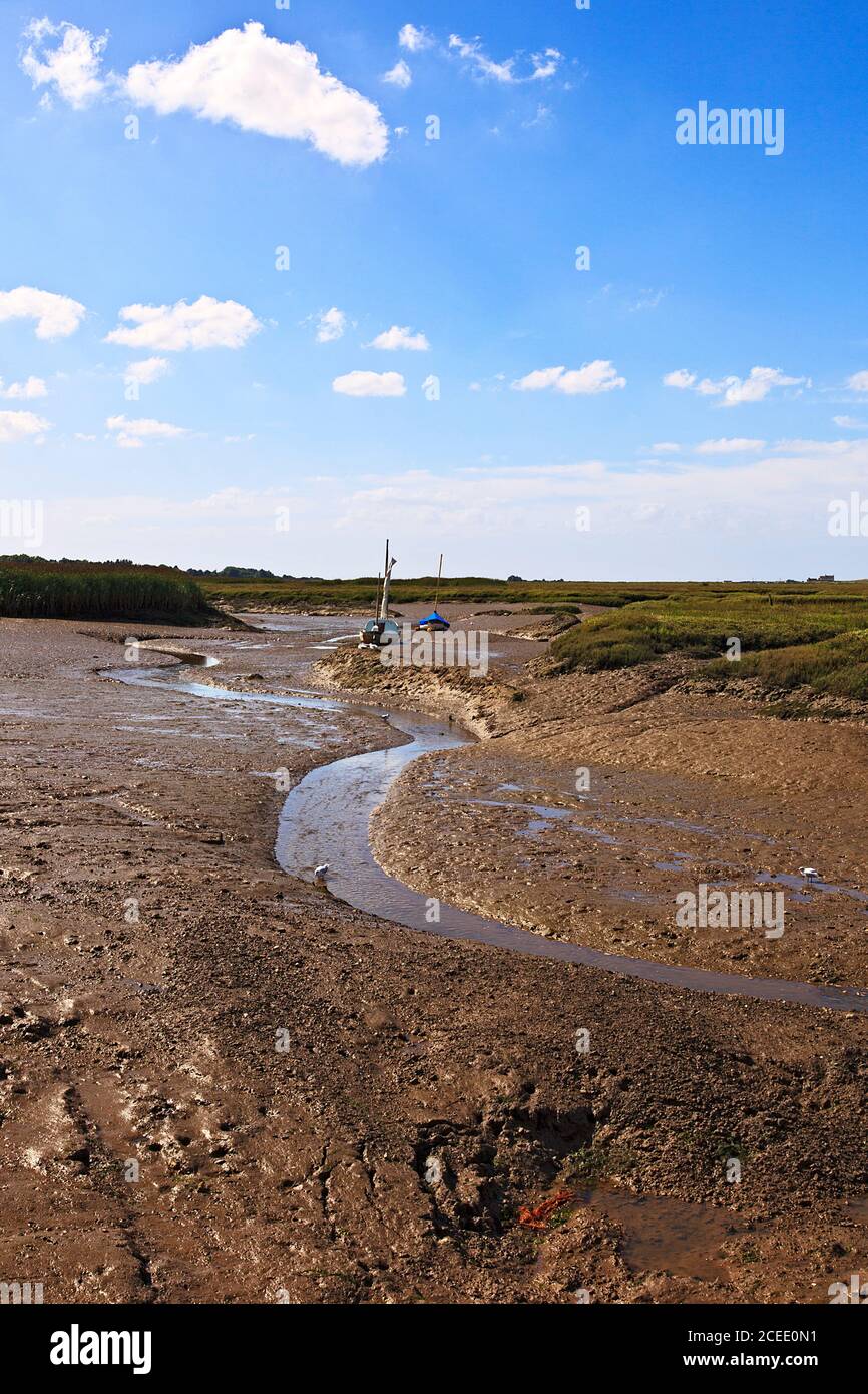 Muddy Creek a Low Tide a Brancaster Staithe sulla costa di Norfolk, Regno Unito Foto Stock