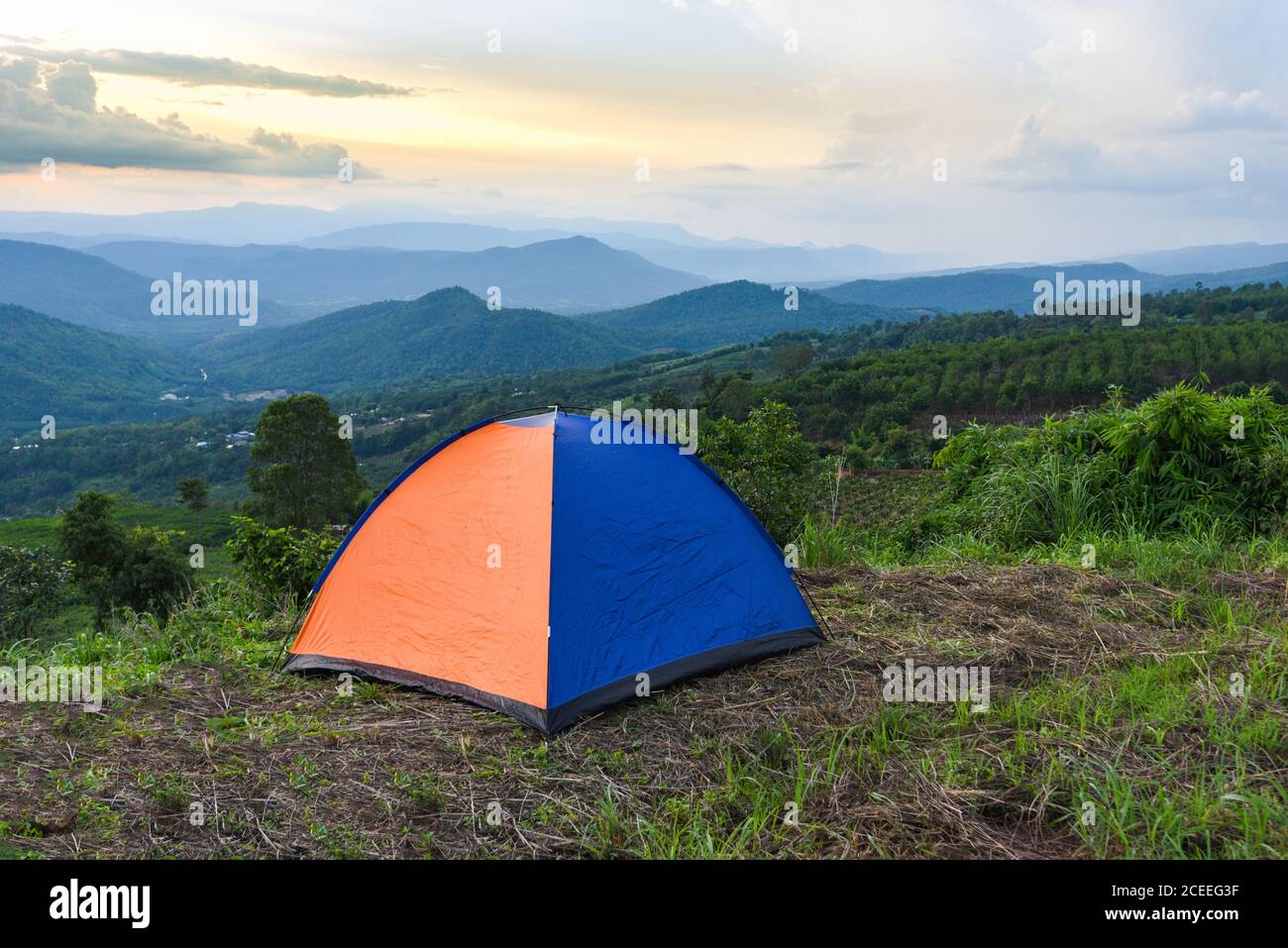 tent camping on the mountains landscape background / adventure travel camping tent in summer season Foto Stock