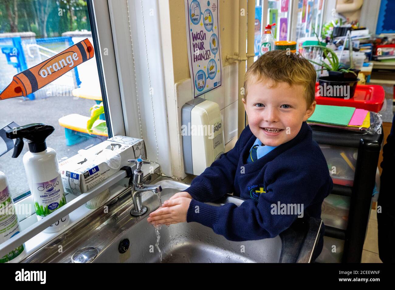 Oisin Hicks lavando la mano il suo primo giorno di P1 alla St John the Baptist Primary School a Belfast ovest, poiché quasi tutte le scuole si sono riaperte e oltre 300,000 studenti sono tornati a scuola in Irlanda del Nord per la prima volta da metà marzo. Foto Stock