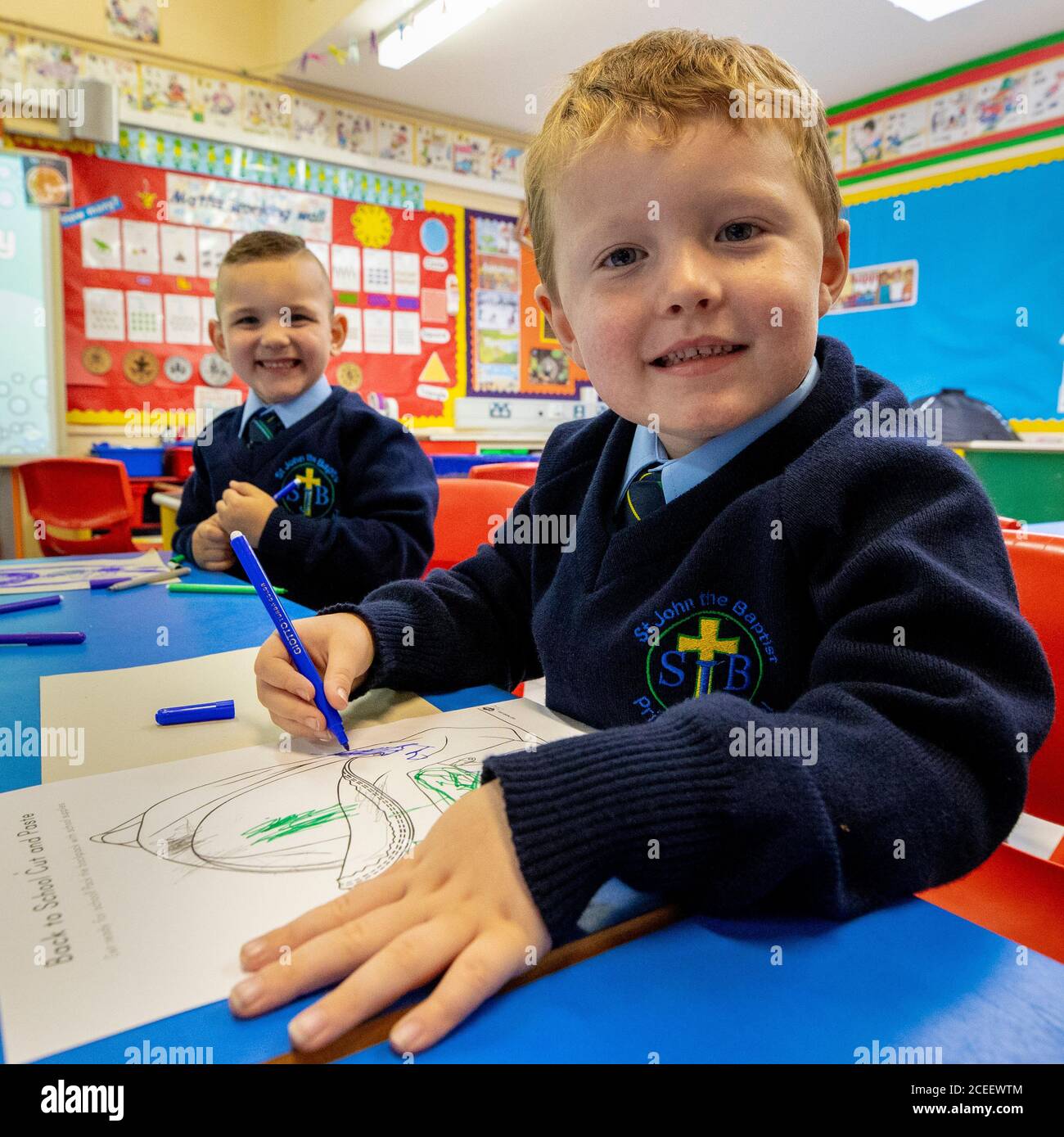 Oisin Hicks (a destra) e Leo di Vecsi si colorano il primo giorno di P1 alla St John the Baptist Primary School di Belfast ovest, poiché quasi tutte le scuole si sono riaperte e oltre 300,000 alunni sono tornati a scuola in Irlanda del Nord per la prima volta da metà marzo. Foto Stock