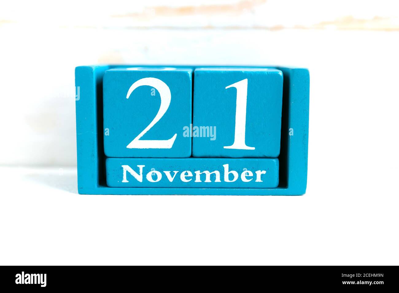 Novembre 21. Calendario cubo blu con mese e data su sfondo di legno. Foto Stock