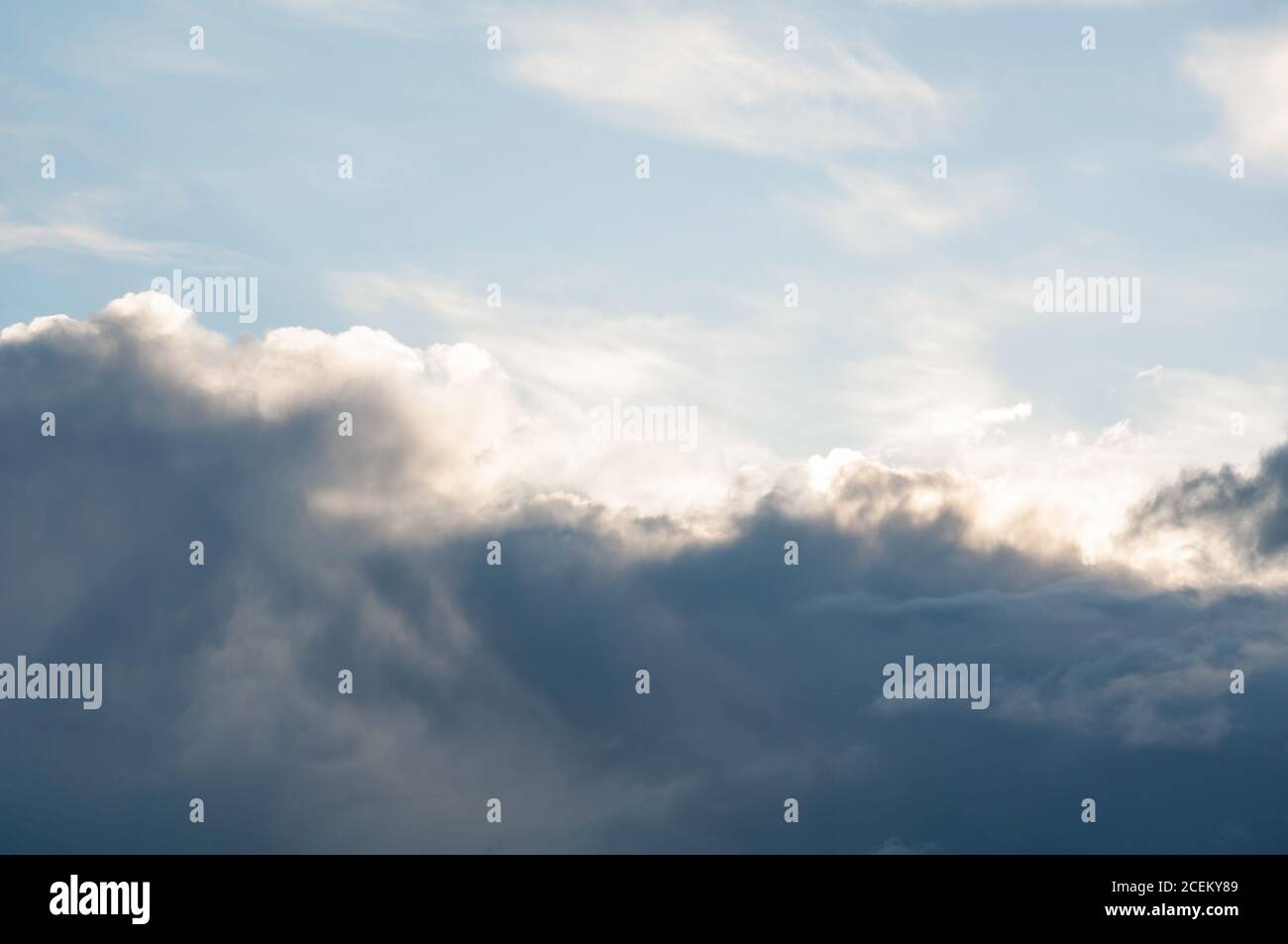 Nuvola modello sole che infrangono attraverso nuvole scure per concetti di tempo, speranza, atmosfera e altri argomenti della natura. Foto Stock