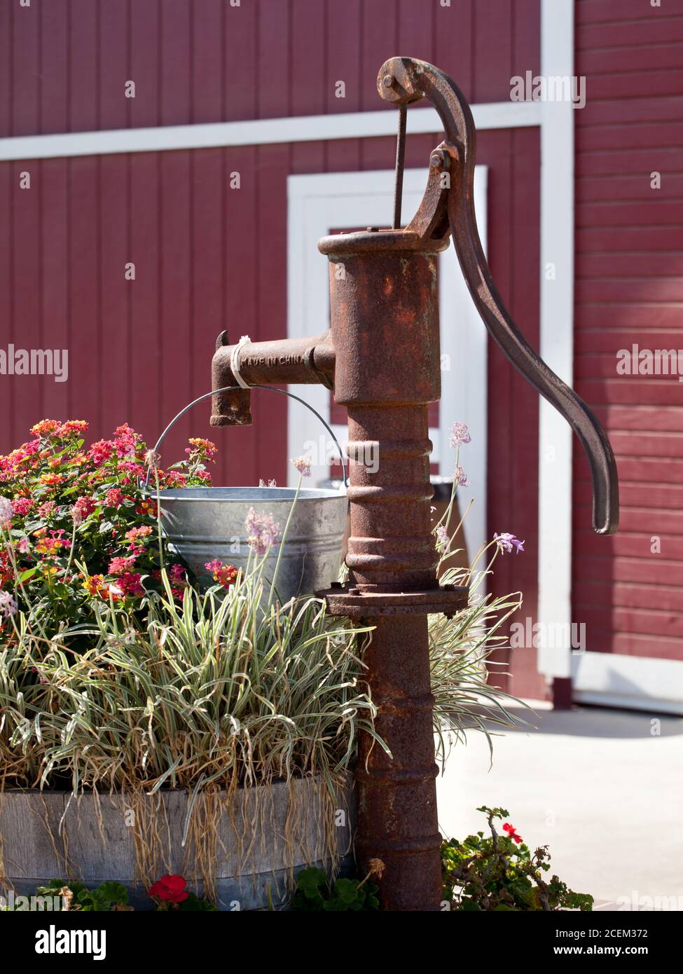 Pompa dell'acqua vecchio stile di fronte ad un fienile Foto Stock