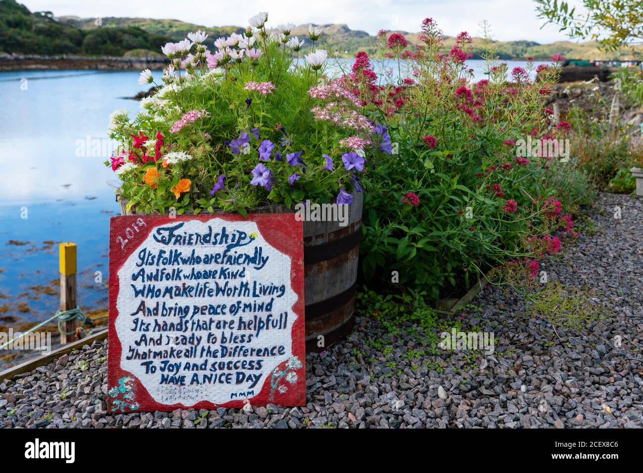 Lungomare con giardini e fiori nel villaggio di Charlestown su Gairloch, Wester Ross, Scozia, Regno Unito Foto Stock