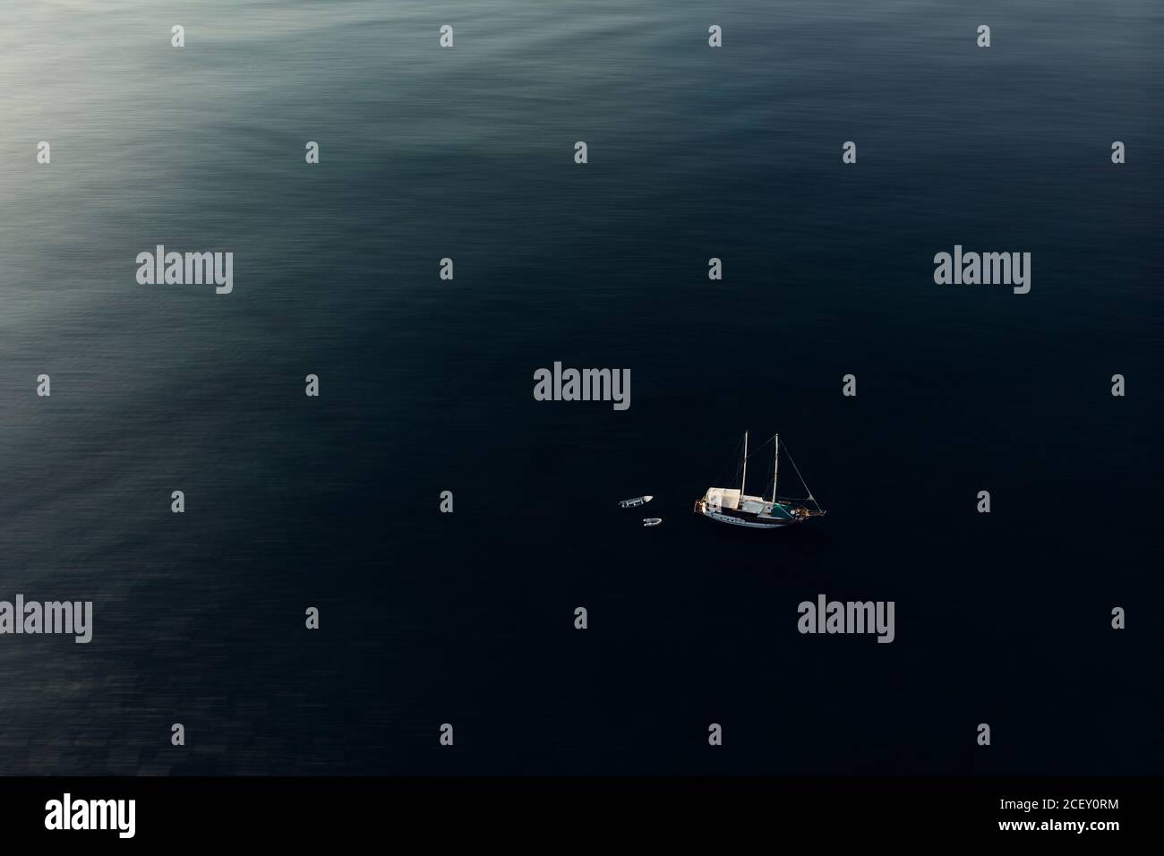 Dall'alto di varie barche a motore moderne che galleggiano sulla calma superficie del mare durante la giornata di sole Foto Stock