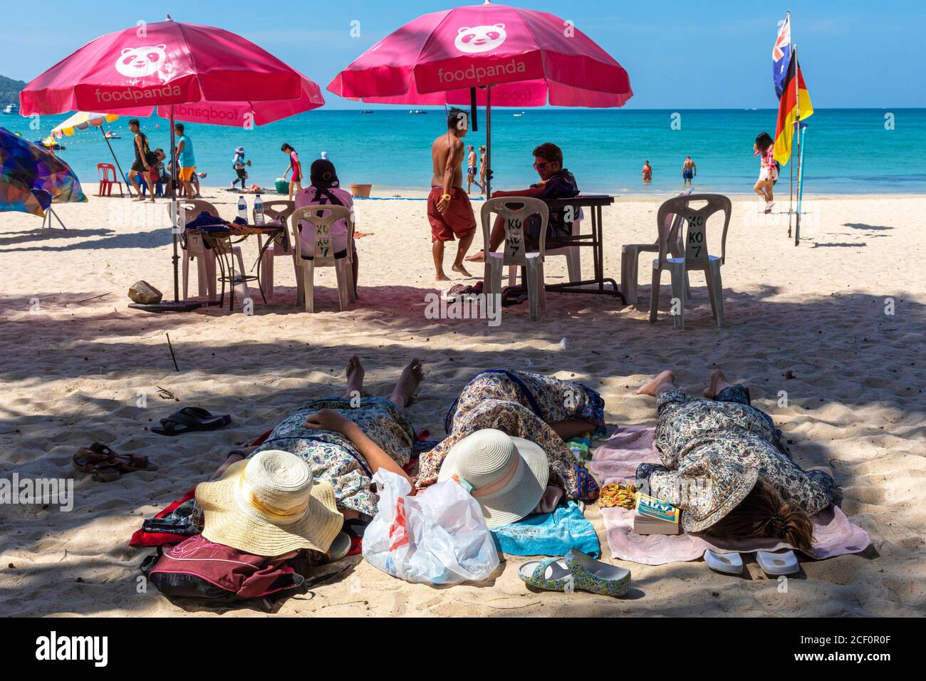 Turisti che dormono sulla spiaggia, Patong, Phuket, Thailandia Foto Stock