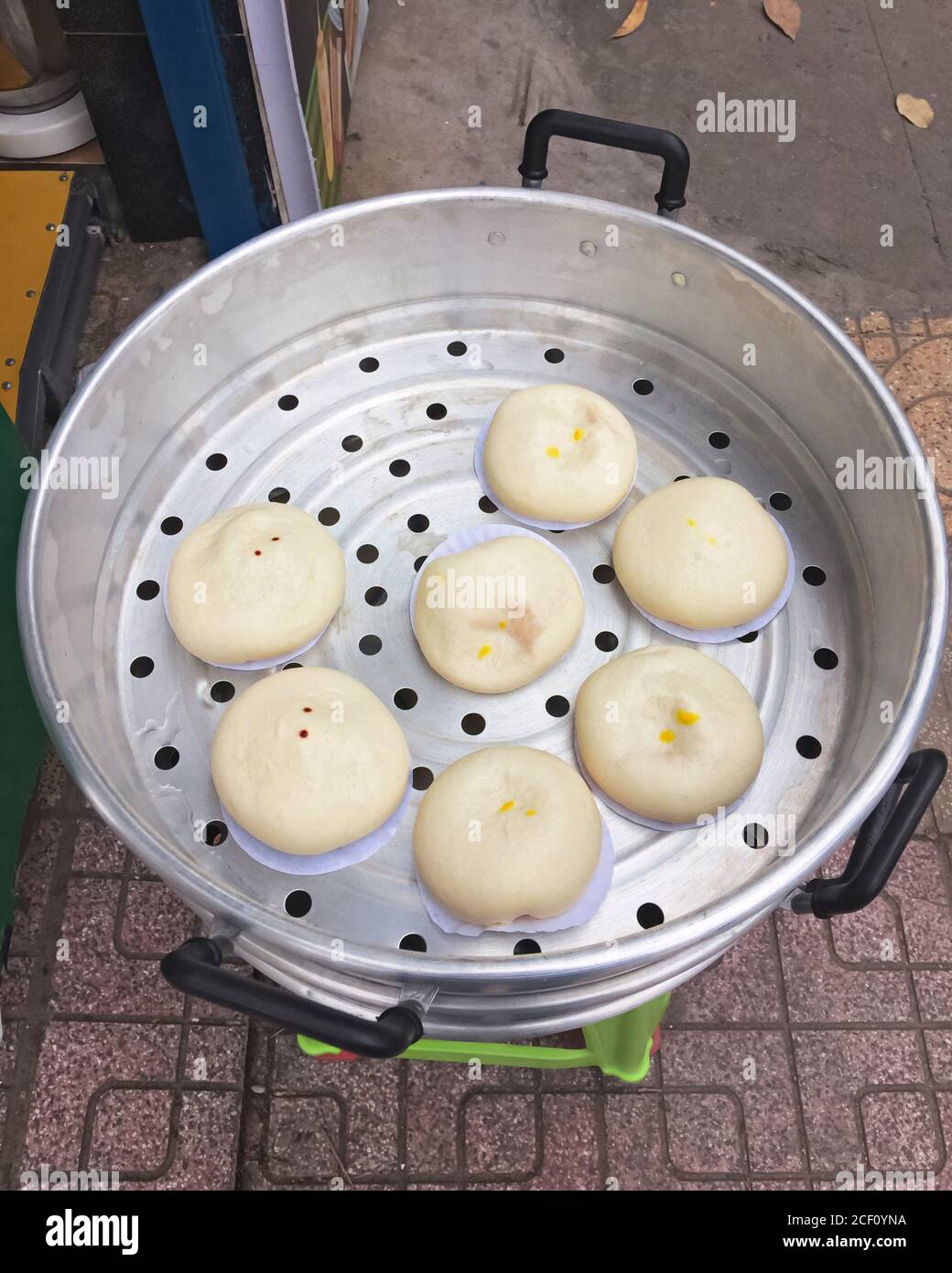 Gnocchi tradizionali vietnamiti di farina di riso al vapore Banh Bao Tuoi durante la cottura. Vista dall'alto. Cibo di strada asiatico. Foto Stock
