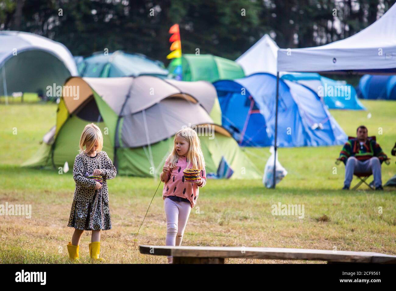 Due ragazze che camminano attraverso il campo di campeggio a noi Non sono un festival socialmente distanziato evento a Pippingford Park - campeggio con atmosfera da festa Foto Stock