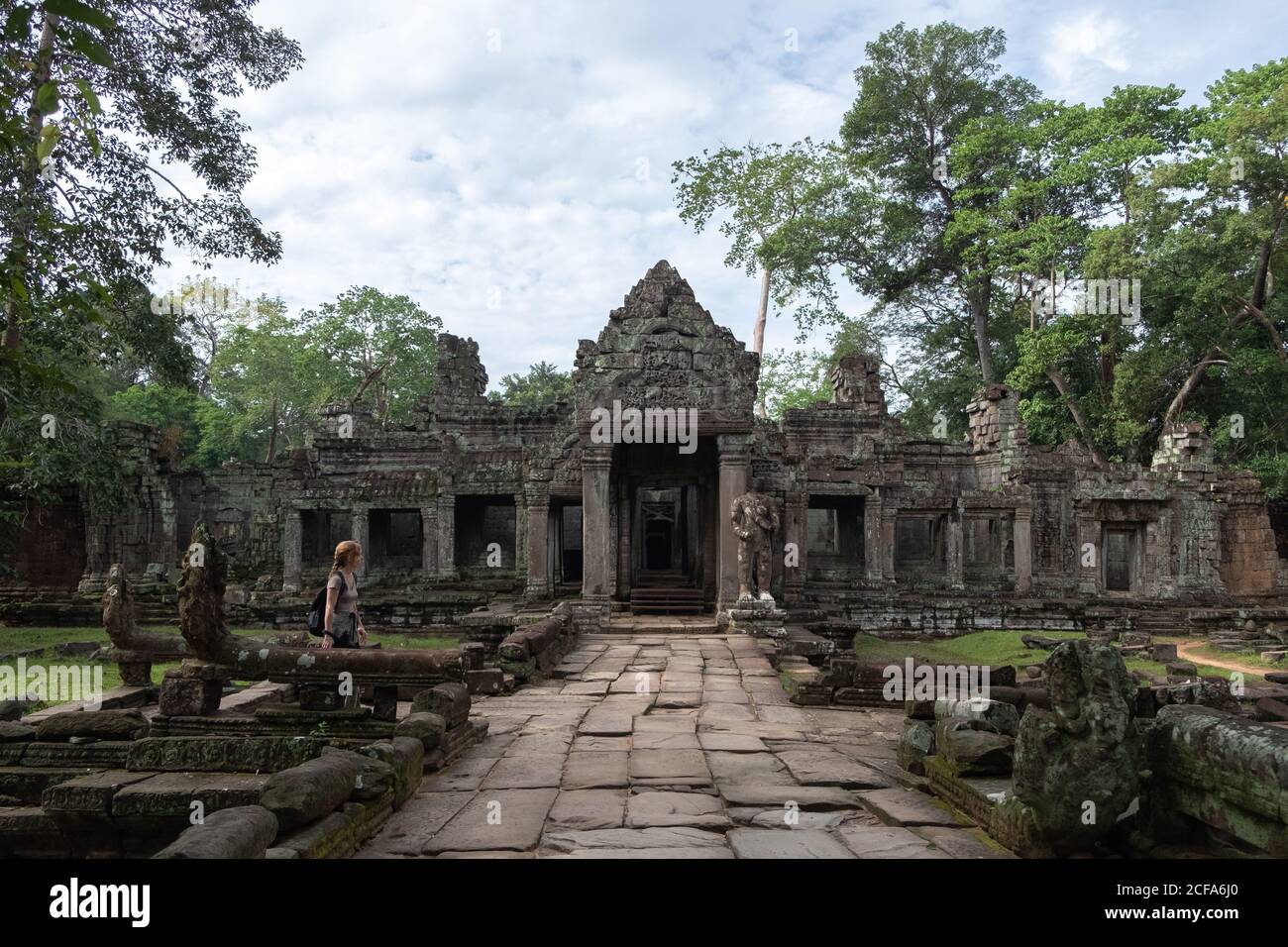 Vista laterale della donna godendo la vacanza mentre si guardano le rovine del tempio religioso di Angkor Wat in Cambogia Foto Stock