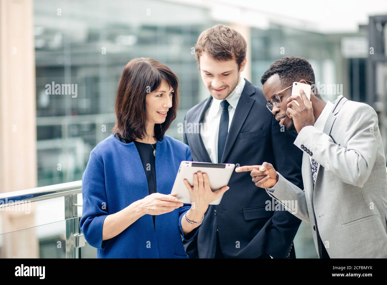 Team di colleghi multietnica lavorando insieme su atablet. Foto Stock
