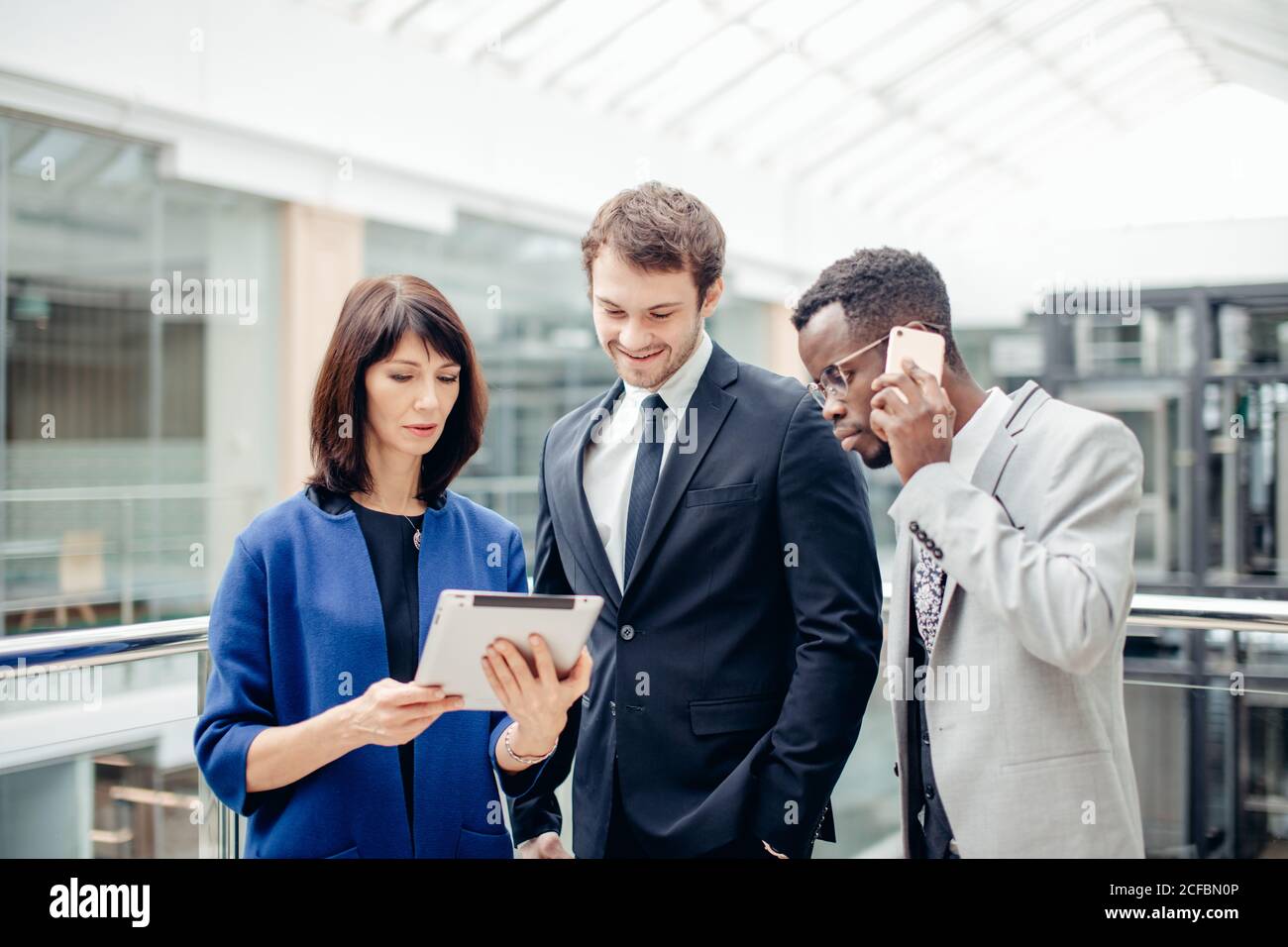Team di colleghi multietnica lavorando insieme su atablet. Foto Stock