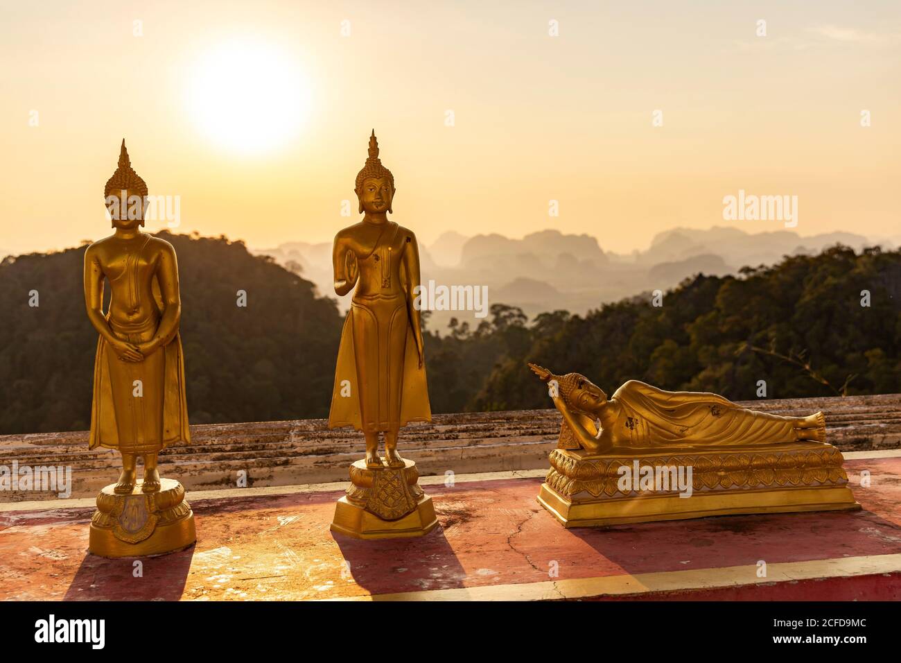 Statue di Buddha al tramonto sulla Tiger Cave Mountain, Tempio della Grotta della Tigre, Città di Krabi, Thailandia Foto Stock