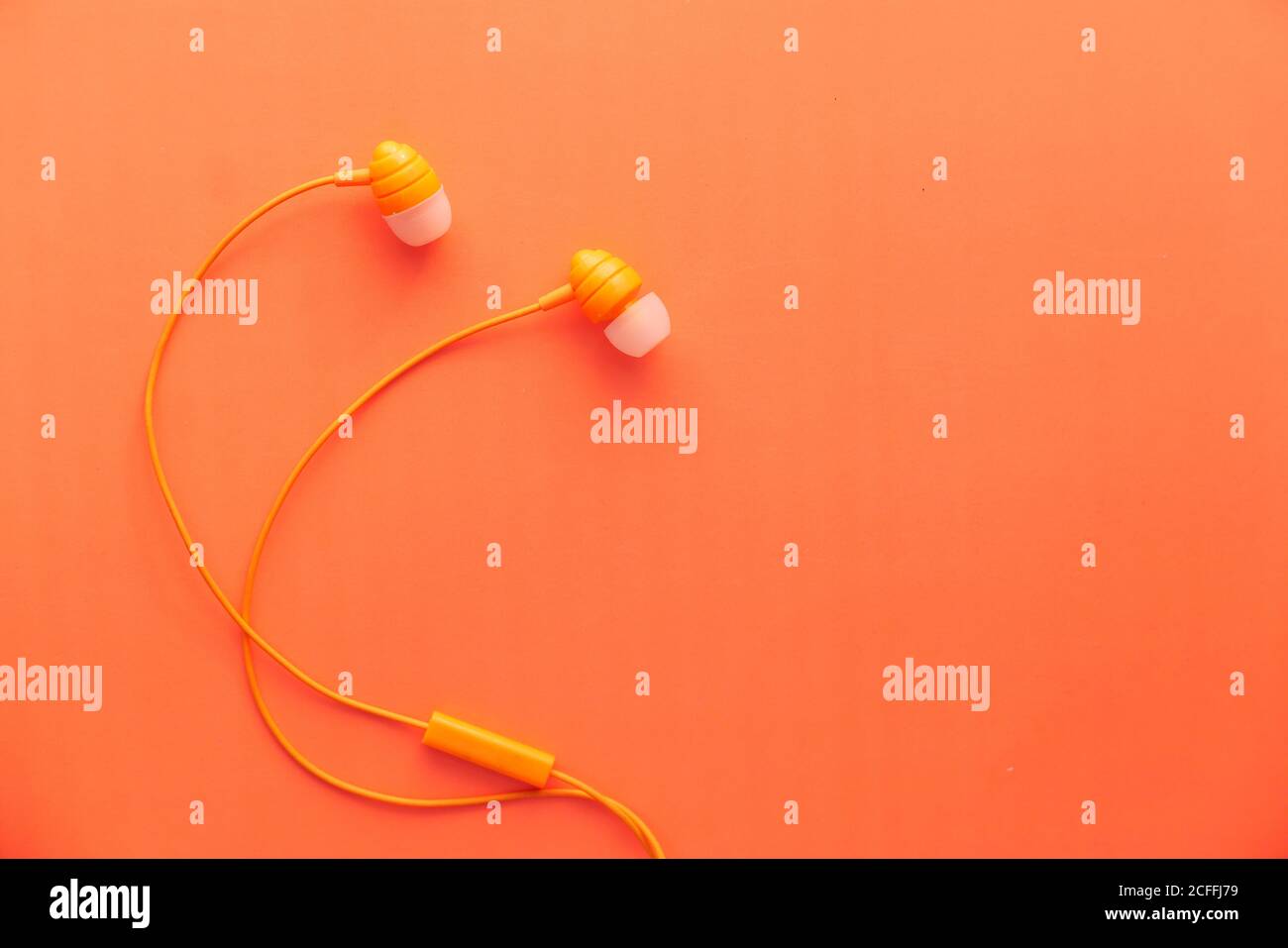 auricolare su sfondo arancione con spazio per la copia Foto Stock