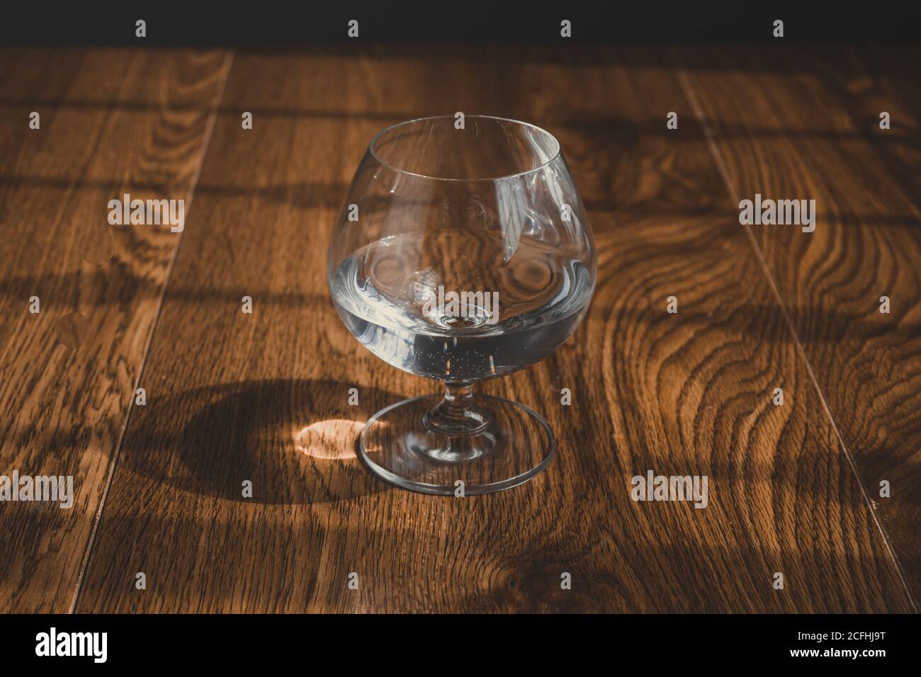 vetro con liquore limpido. come mezcal, tequila di cristallo, o vodka.on tavole di quercia Foto Stock
