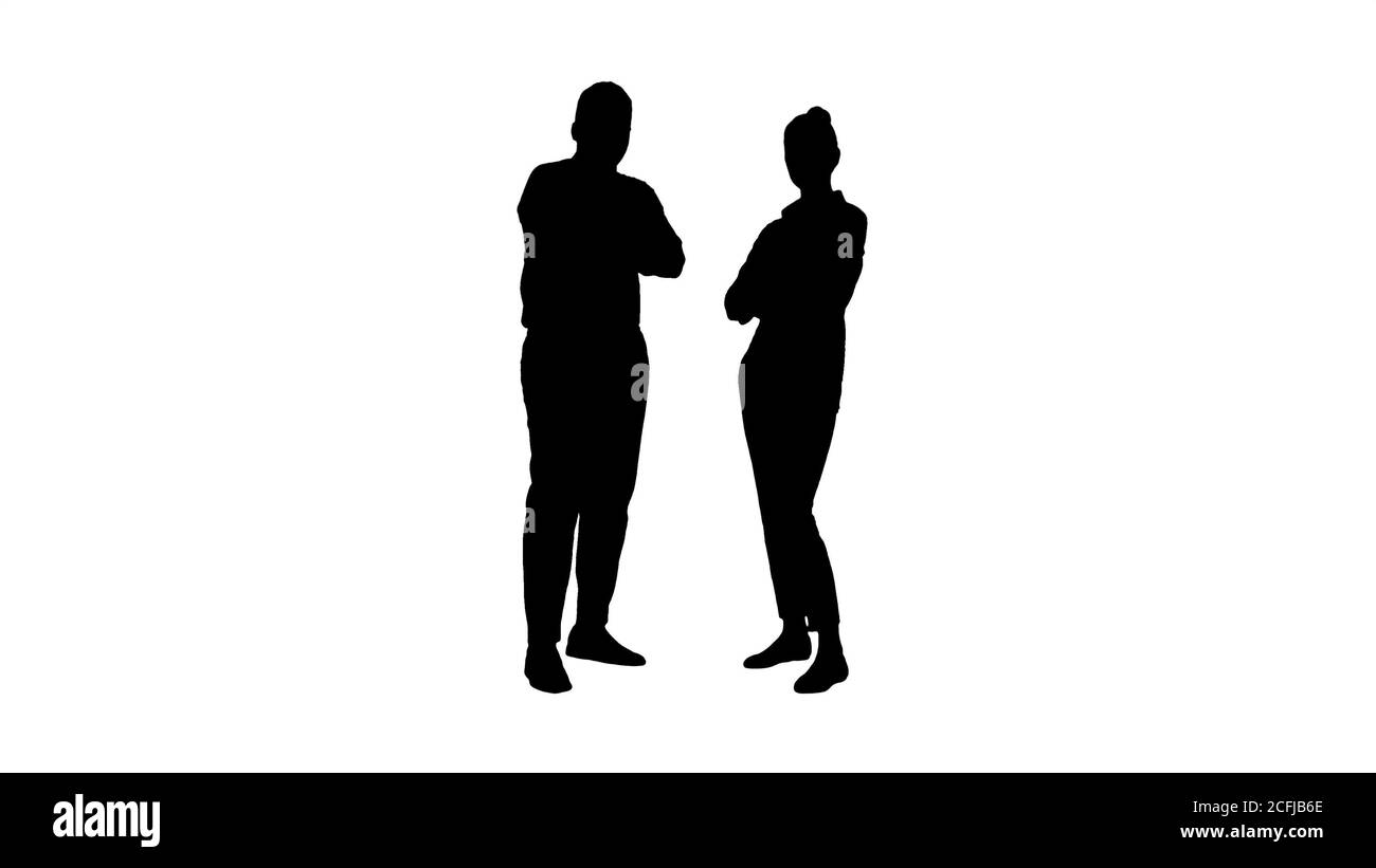 Silhouette International uomini d'affari in piedi con le braccia ripiegate. Foto Stock