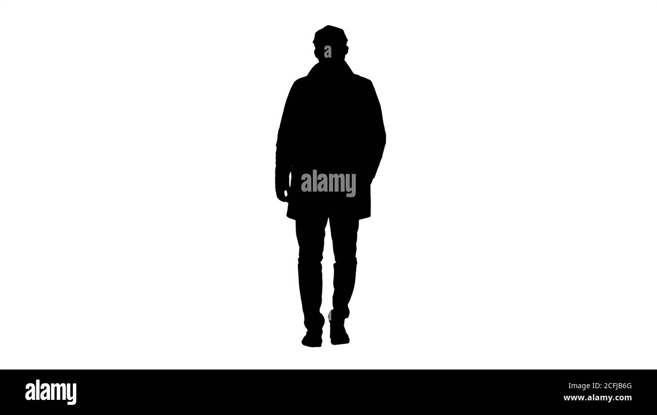 Silhouette uomo bello in abiti alla moda passeggiate e sorridente. Foto Stock