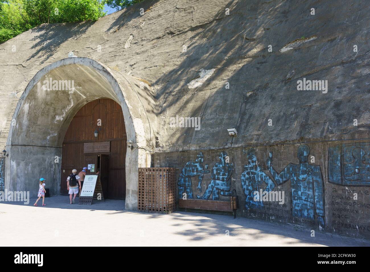 Russia, regione di Krasnodar, Novorossiysk, villaggio di Abrau-Durso - 12 giugno 2018: I turisti entrano nel negozio aziendale Grotto, le cui pareti sono decorate Foto Stock