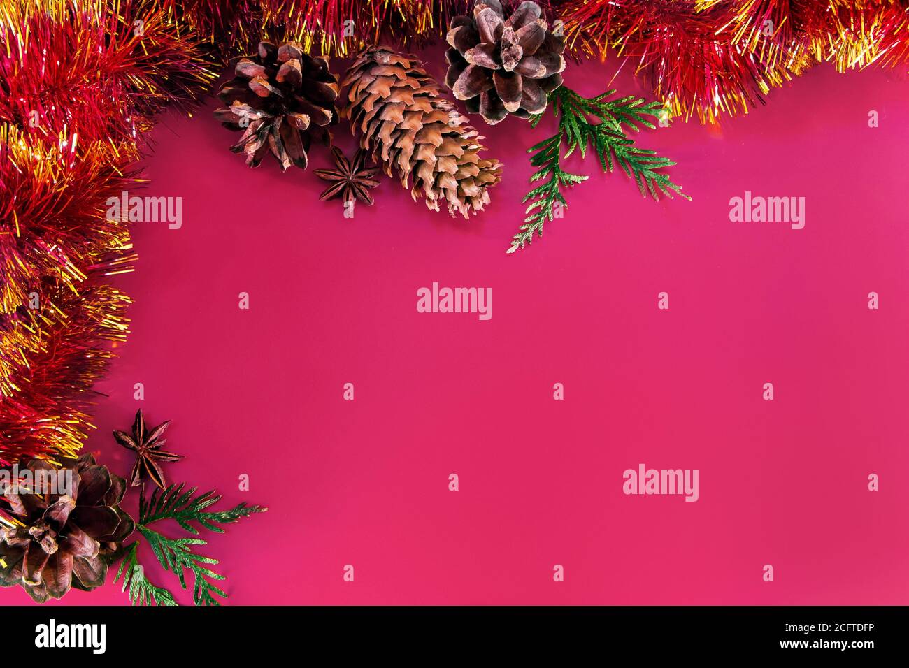 Decorazioni natalizie - coni, palle natalizie e rami su sfondo rosa. Aroma candela per una piacevole vacanza. Inserire il testo. Foto Stock