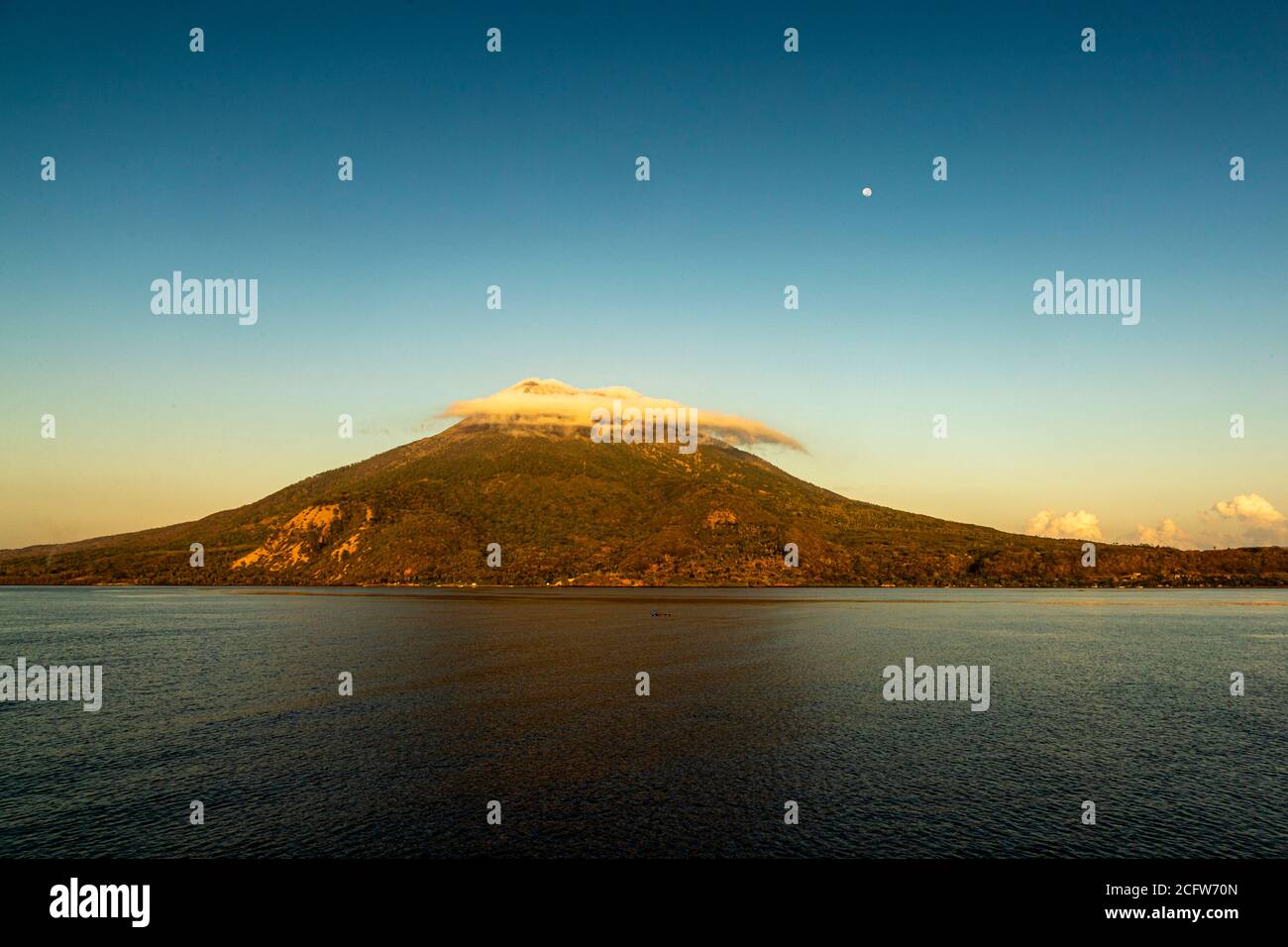 Isola vulcanica indonesiana dietro un sipario di nuvole, Isole Sunda, Indonesia Foto Stock