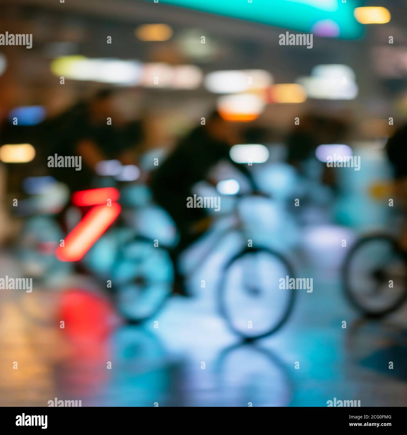 Silhouette di astratte persone irriconoscibili, bici da corsa, città notturna, bokeh illuminazione, sfocatura movimento. Stile di vita sano, concetto di attività per il tempo libero. Foto Stock