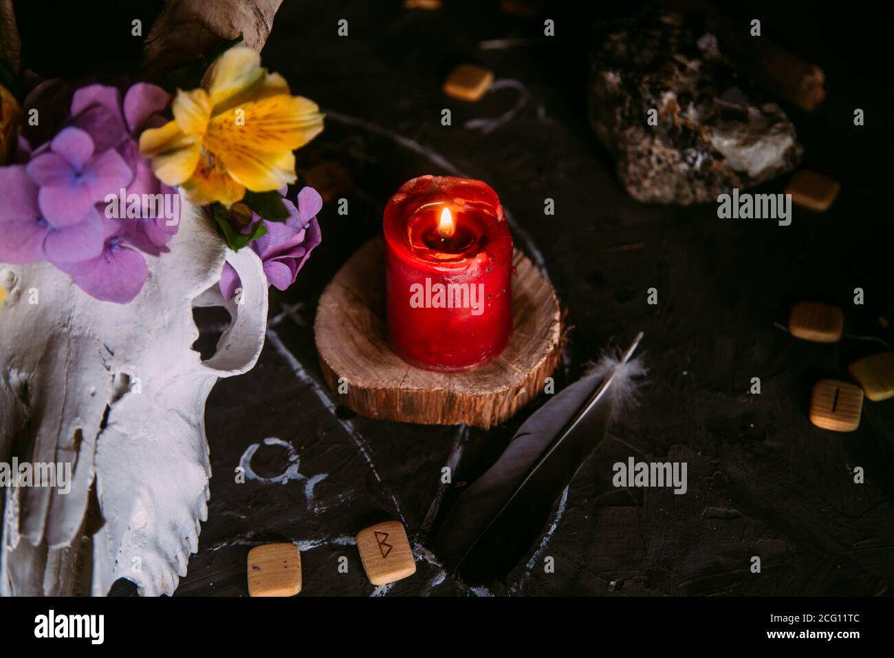 Gabbiano di capra bianco con corna, fiori, libro aperto vecchio, candele sul tavolo delle streghe. Concetto occulto, esoterico, divinazione e wicca. Halloween, giorno della dea Foto Stock