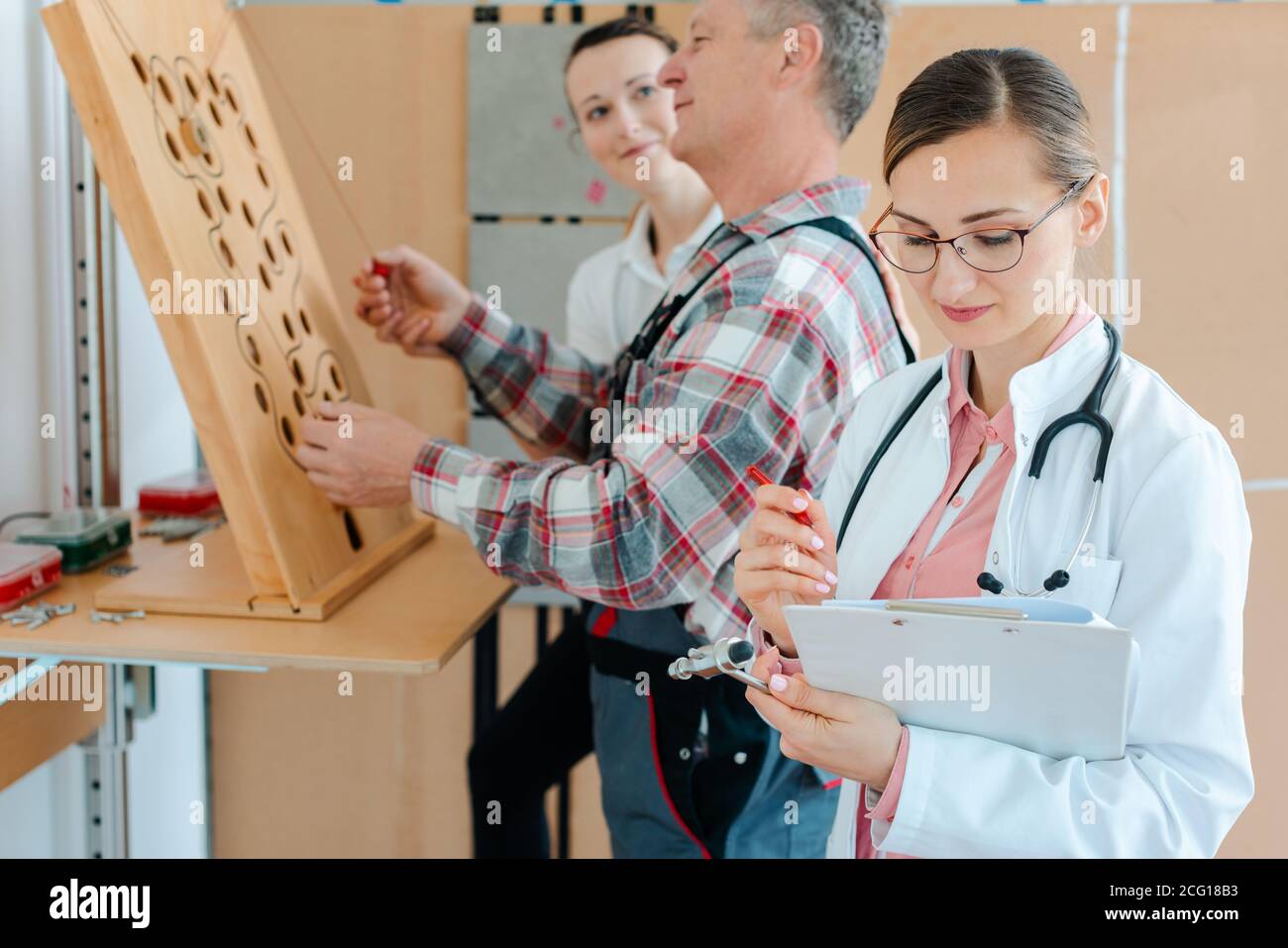 Il medico annoterà i risultati del test di destrezza della terapia occupazionale Foto Stock