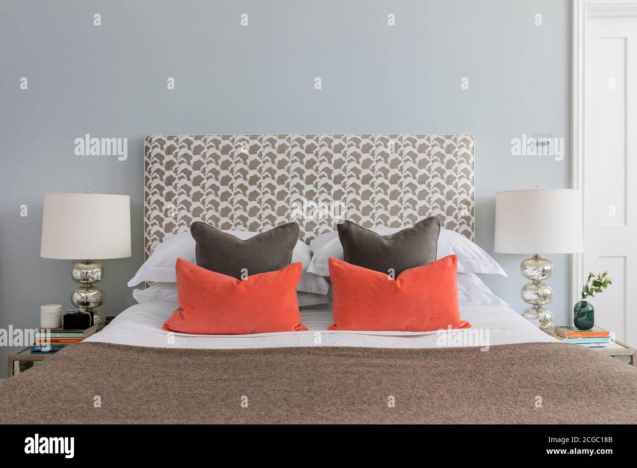 Cuscini su un letto in un appartamento ristrutturato a Hove, East Sussex, UK. Foto Stock