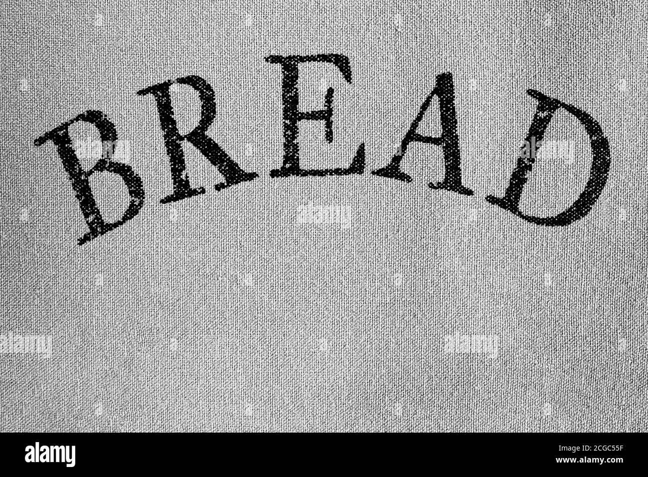 la parola pane in lettere nere su tessuto grigio chiaro tessuto Foto Stock