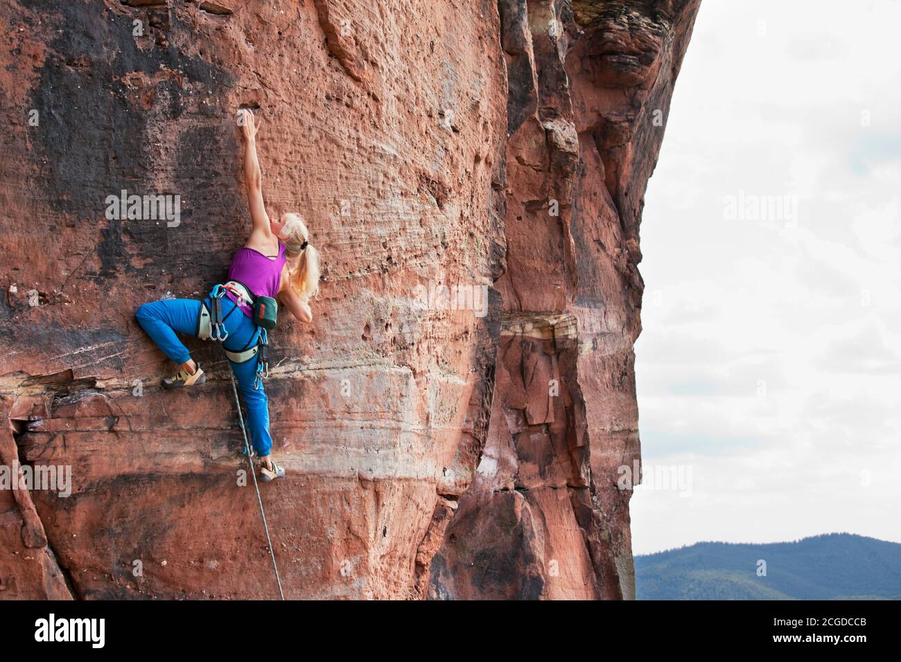 Giovane bionda che arrampica una roccia estrema diffonde - Veronika Frank a Rötzenstein - Pfalz Foto Stock