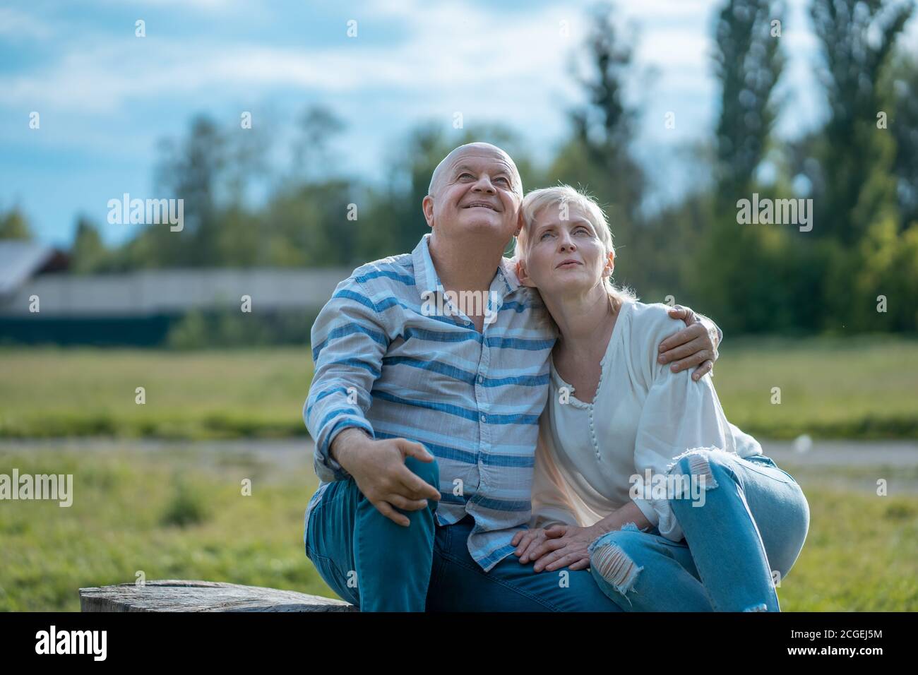 felice coppia senior dating e hugging e parlare nel parco in giornata di sole Foto Stock