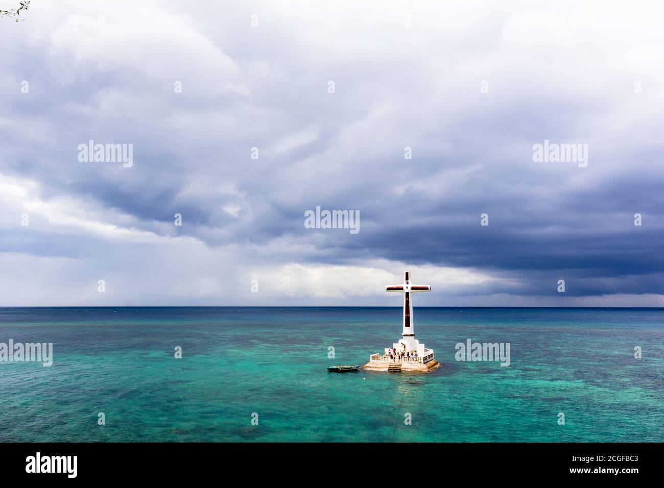 Una croce gigante segna il cimitero sommerso al largo dell'isola di Camiguin Foto Stock