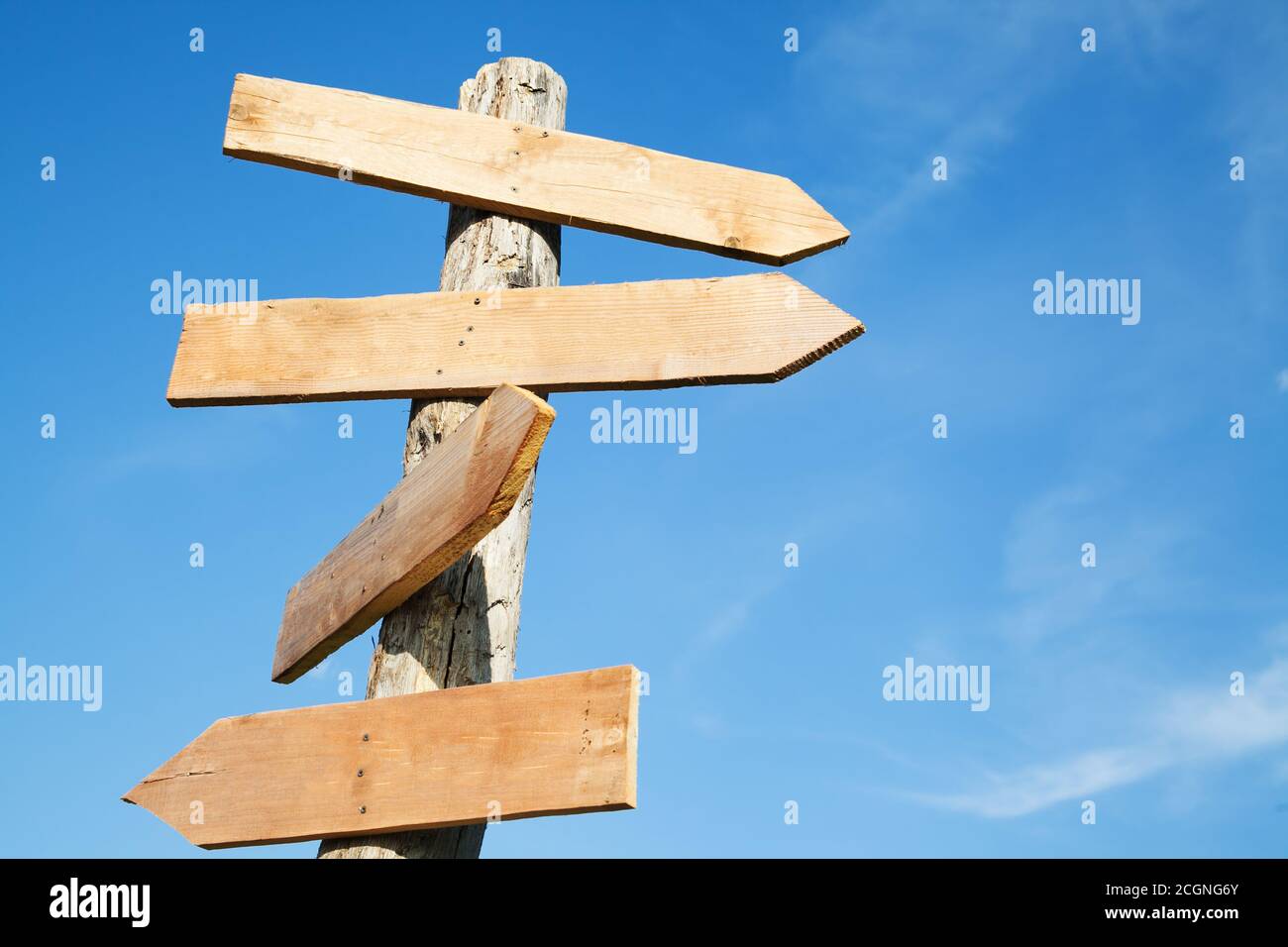 Cartelli a forma di freccia in legno vuoto contro il cielo blu Foto Stock