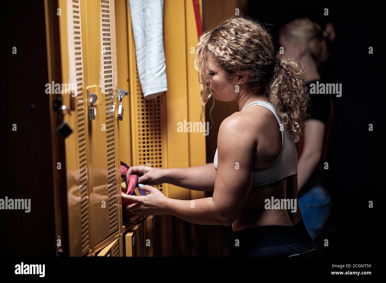 Ragazza giovane in un armadietto che si prepara per un fitness Foto Stock